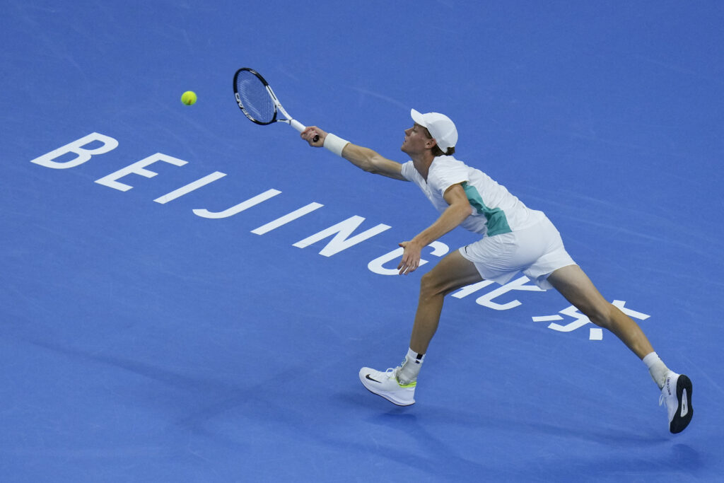 Jannik Sinner of Italy hits a return shot against Carlos Alcaraz of Spain during the men's singles semifinal match in the China Open tennis tournament at the Diamond Court in Beijing, Tuesday, Oct. 3, 2023. (AP Photo/Andy Wong)