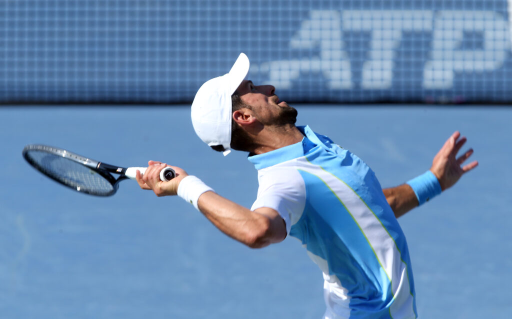 epa10811080 Novak Djokovic of Serbia serves to Carlos Alcaraz of Spain during the final round of the Western and Southern Open at the Lindner Family Tennis Center in Mason Ohio USA, 20 August 2023.  EPA-EFE/MARK LYONS