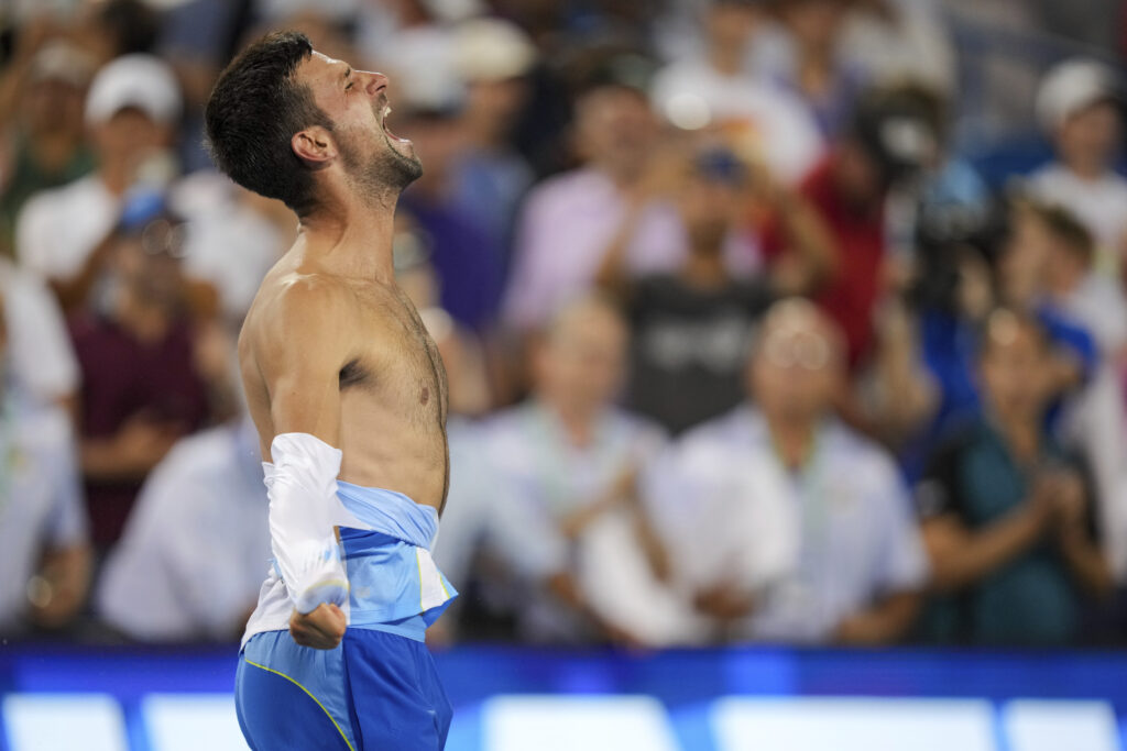 Novak Djokovic, of Serbia, rips his shirt as he celebrates after his win against Carlos Alcaraz, of Spain, in the men's singles final of the Western &amp; Southern Open tennis tournament, Sunday, Aug. 20, 2023, in Mason, Ohio. (AP Photo/Aaron Doster)