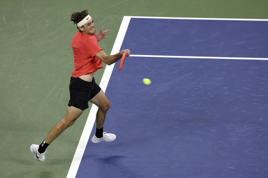 Taylor Fritz, of the United States, returns to Dominic Stricker, of Switzerland, during the fourth round of the U.S. Open tennis championships, Sunday, Sept. 3, 2023, in New York. (AP Photo/Jason DeCrow)