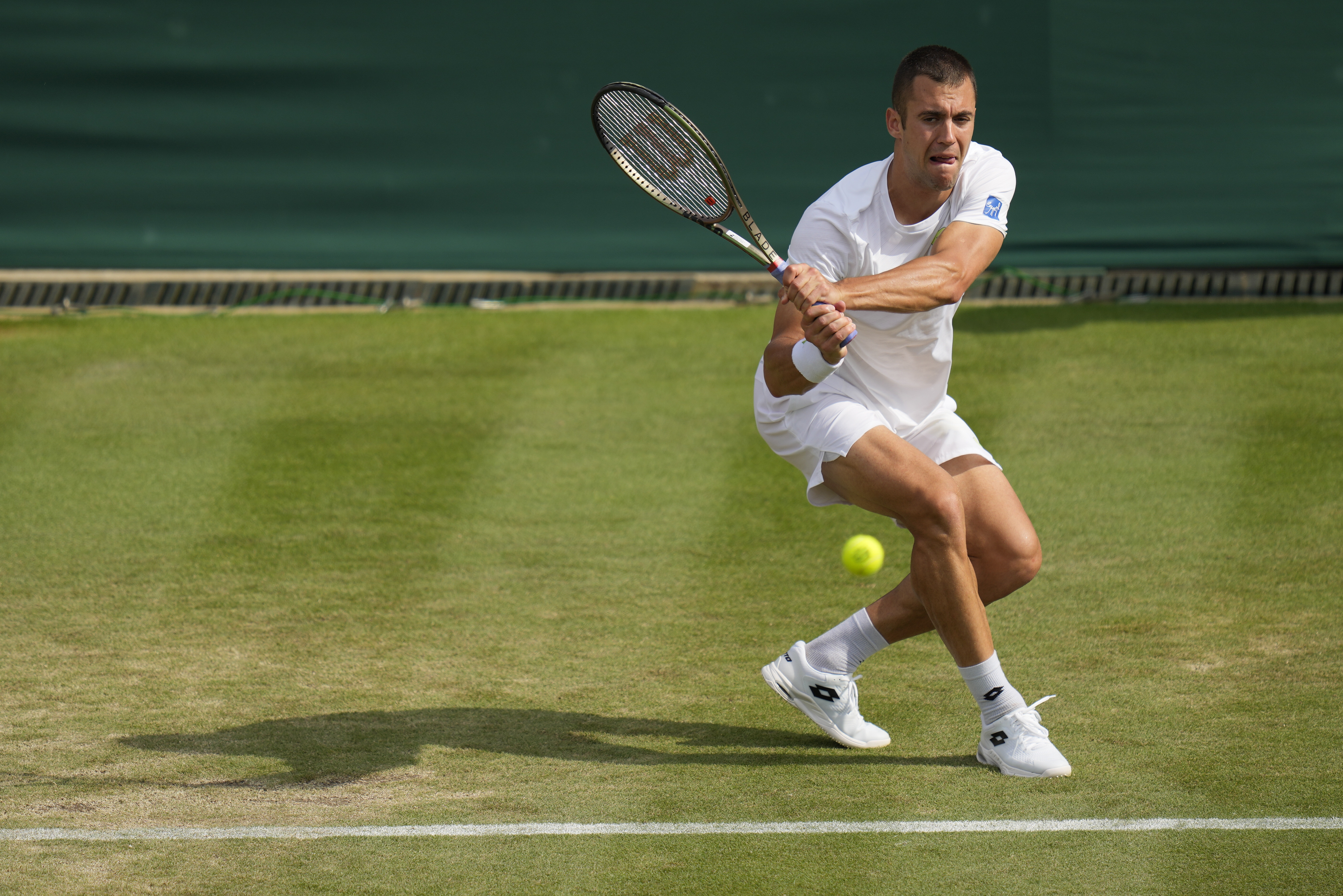 Serbia's Laslo Djere returns to Stefanos Tsitsipas of Greece in a men's singles match on day six of the Wimbledon tennis championships in London, Saturday, July 8, 2023. (AP Photo/Kirsty Wigglesworth)