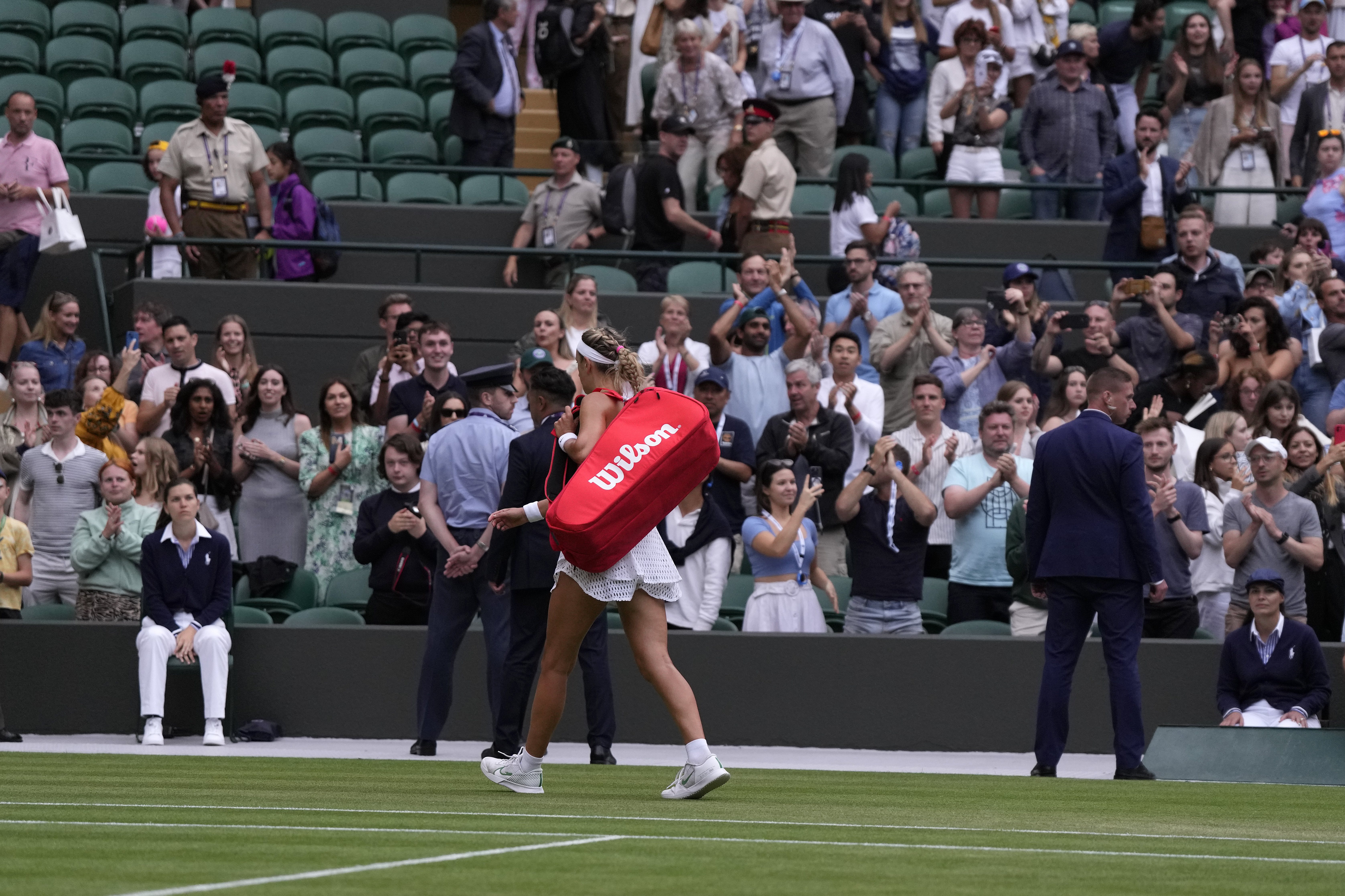Victoria Azarenka of Belarus leaves the court after losing to Ukraine's Elina Svitolina in a women's singles match on day seven of the Wimbledon tennis championships in London, Sunday, July 9, 2023. (AP Photo/Alastair Grant)