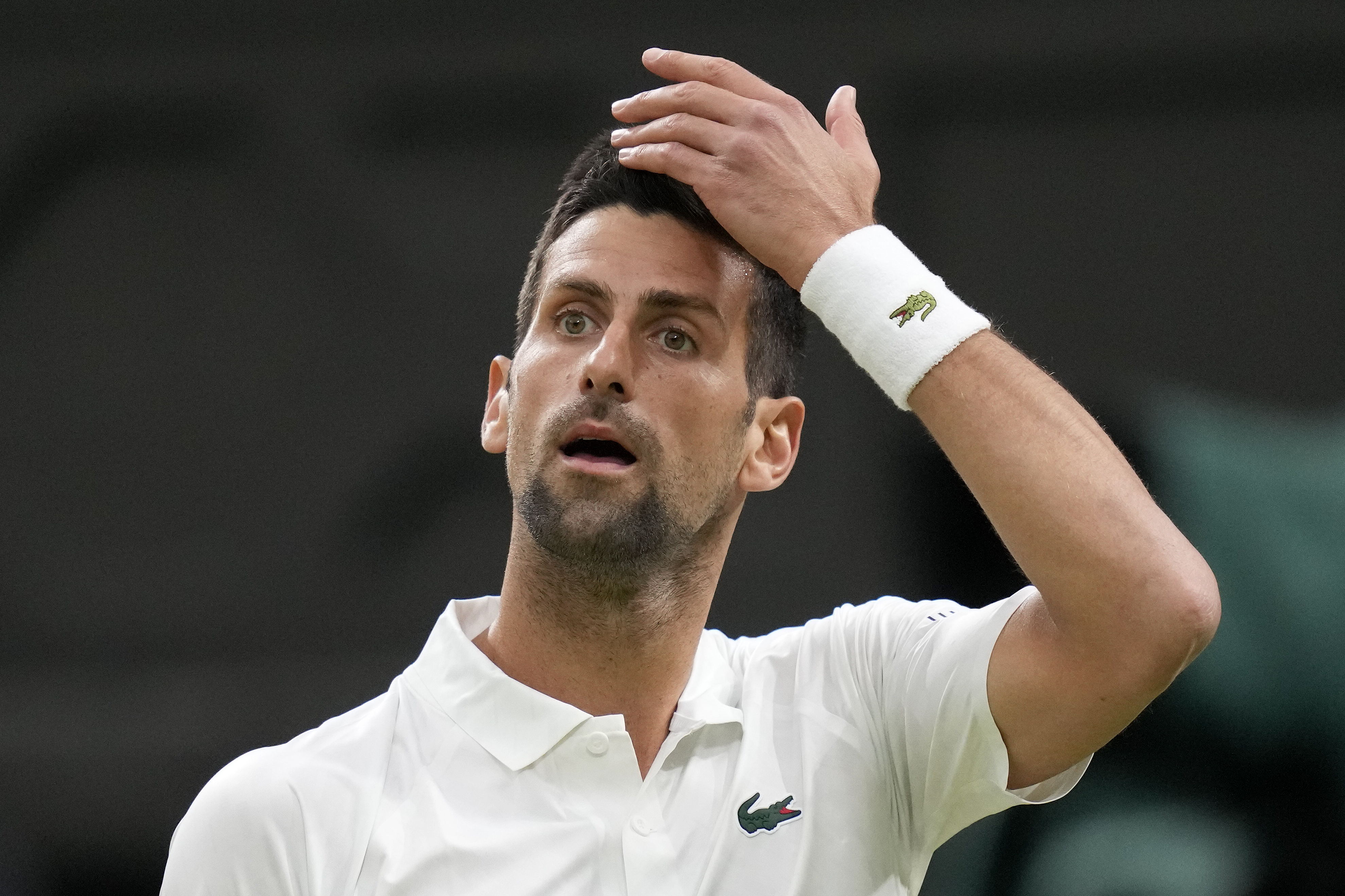 Serbia's Novak Djokovic pauses as he plays Poland's Hubert Hurkacz in a men's singles match on day seven of the Wimbledon tennis championships in London, Sunday, July 9, 2023. (AP Photo/Kirsty Wigglesworth)