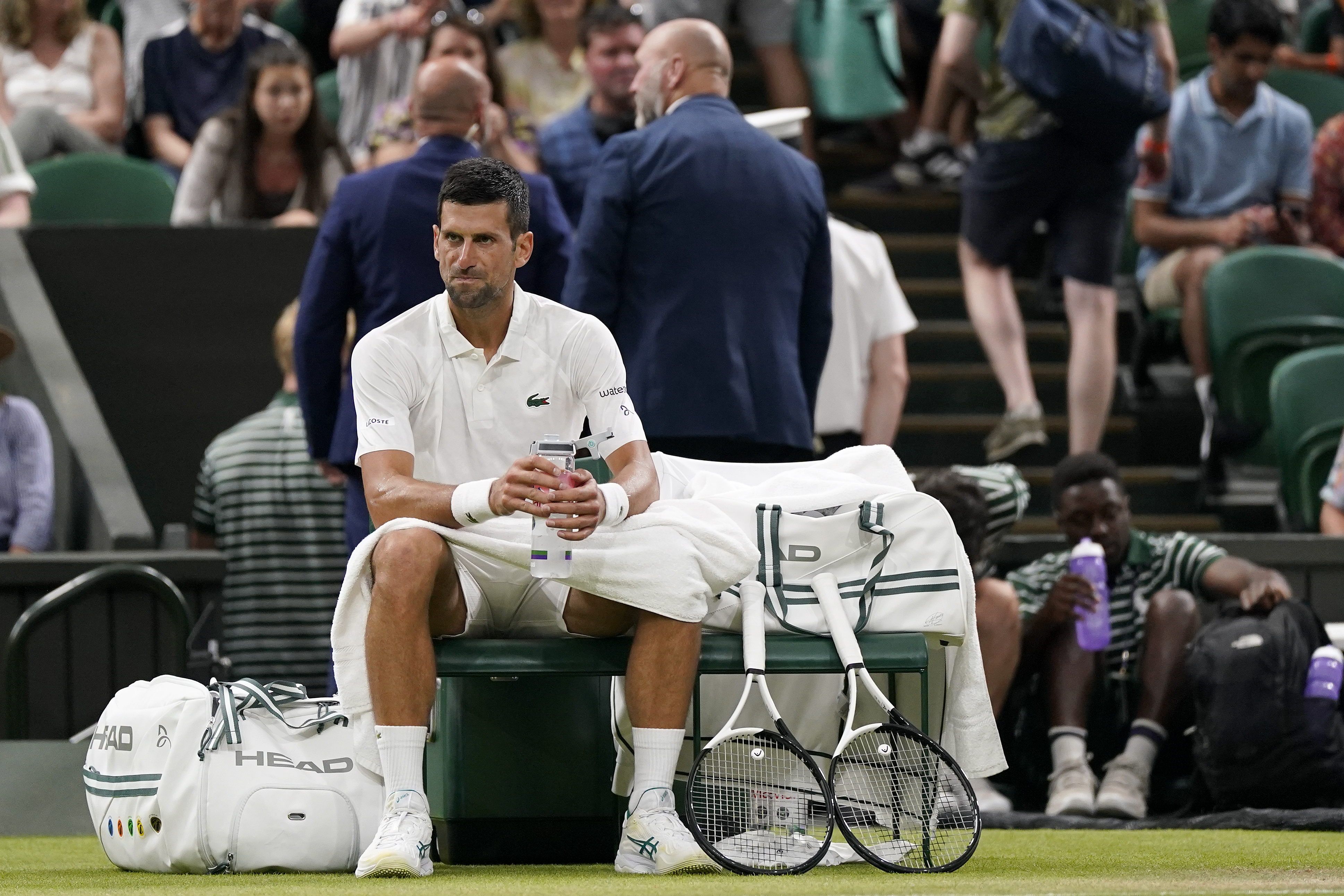 Serbia's Novak Djokovic sits in his chair during a change of ends break as he plays Switzerland's Stan Wawrinka in a men's singles match on day five of the Wimbledon tennis championships in London, Friday, July 7, 2023. (AP Photo/Alberto Pezzali)