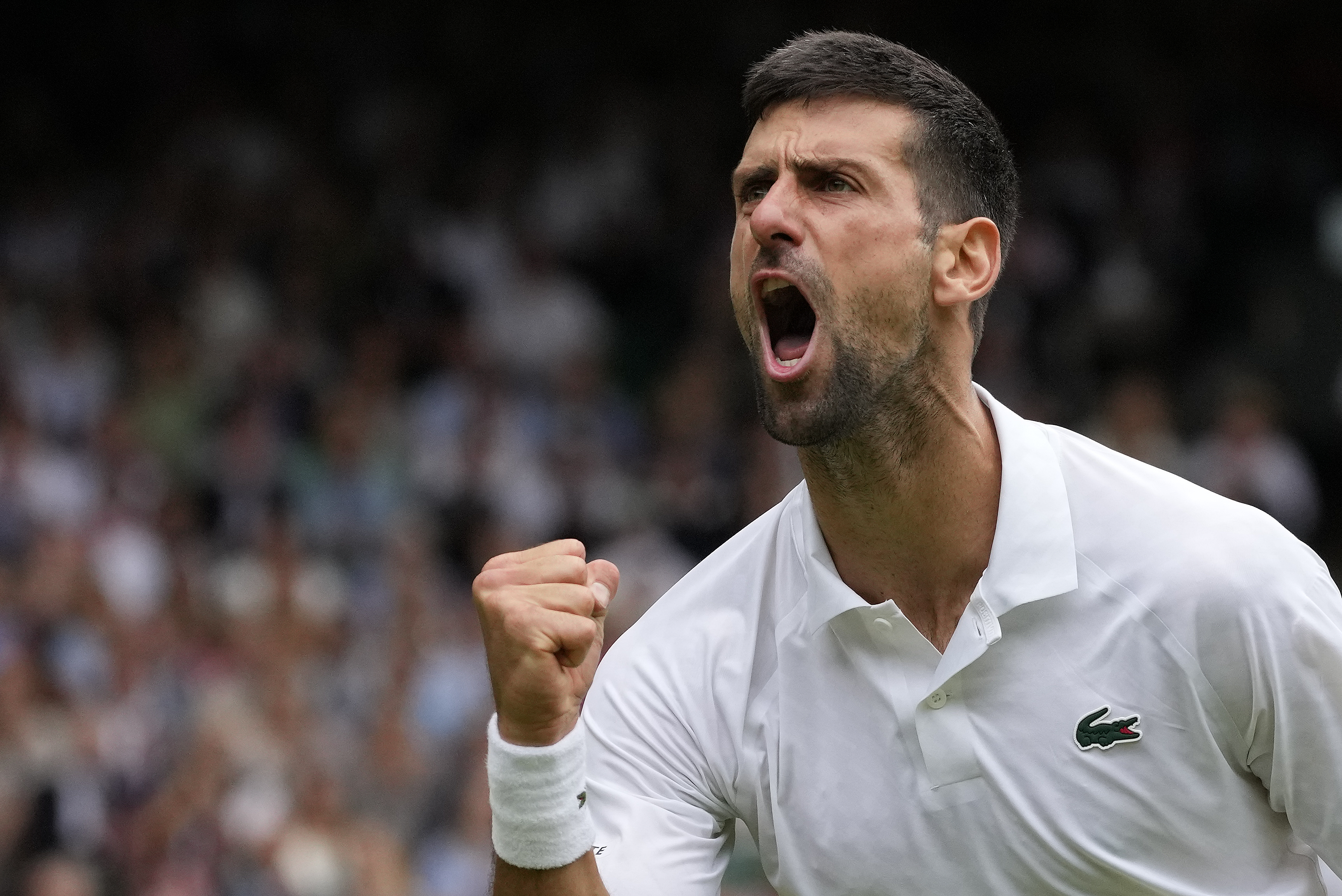 Serbia's Novak Djokovic celebrates winning a point against Russia's Andrey Rublev in a men's singles match on day nine of the Wimbledon tennis championships in London, Tuesday, July 11, 2023. (AP Photo/Kirsty Wigglesworth)