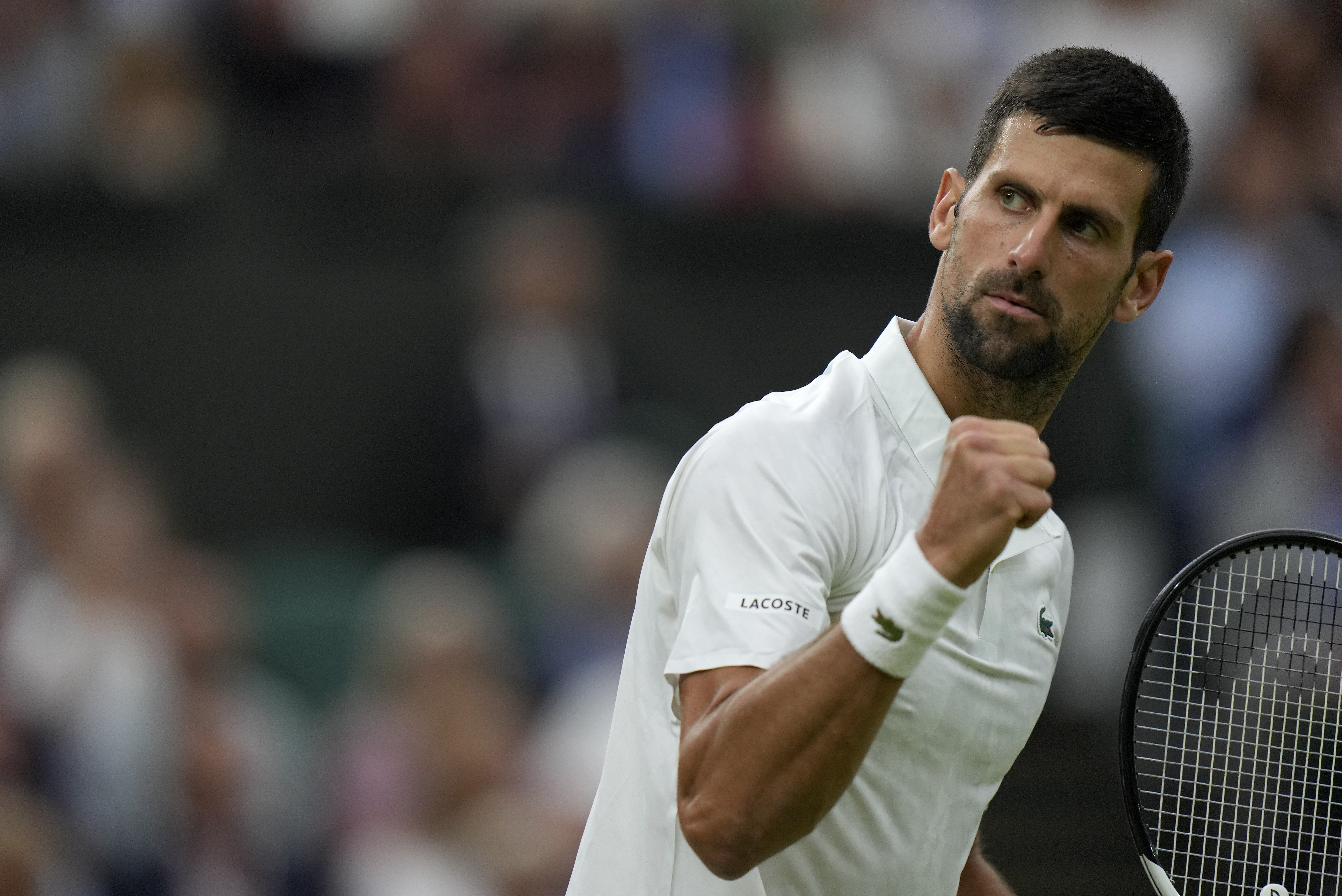 Serbia's Novak Djokovic reacts as he wins the first set against Italy's Jannik Sinner in a men's singles semifinal match on day twelve of the Wimbledon tennis championships in London, Friday, July 14, 2023. (AP Photo/Alastair Grant)