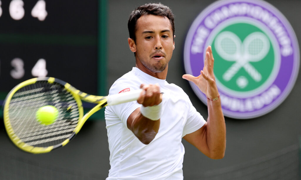 epa10038563 Hugo Dellien of Bolivia in action in the men's first round match against Alex de Minaur of Australia at the Wimbledon Championships, in Wimbledon, Britain, 28 June 2022.  EPA-EFE/KIERAN GALVIN   EDITORIAL USE ONLY