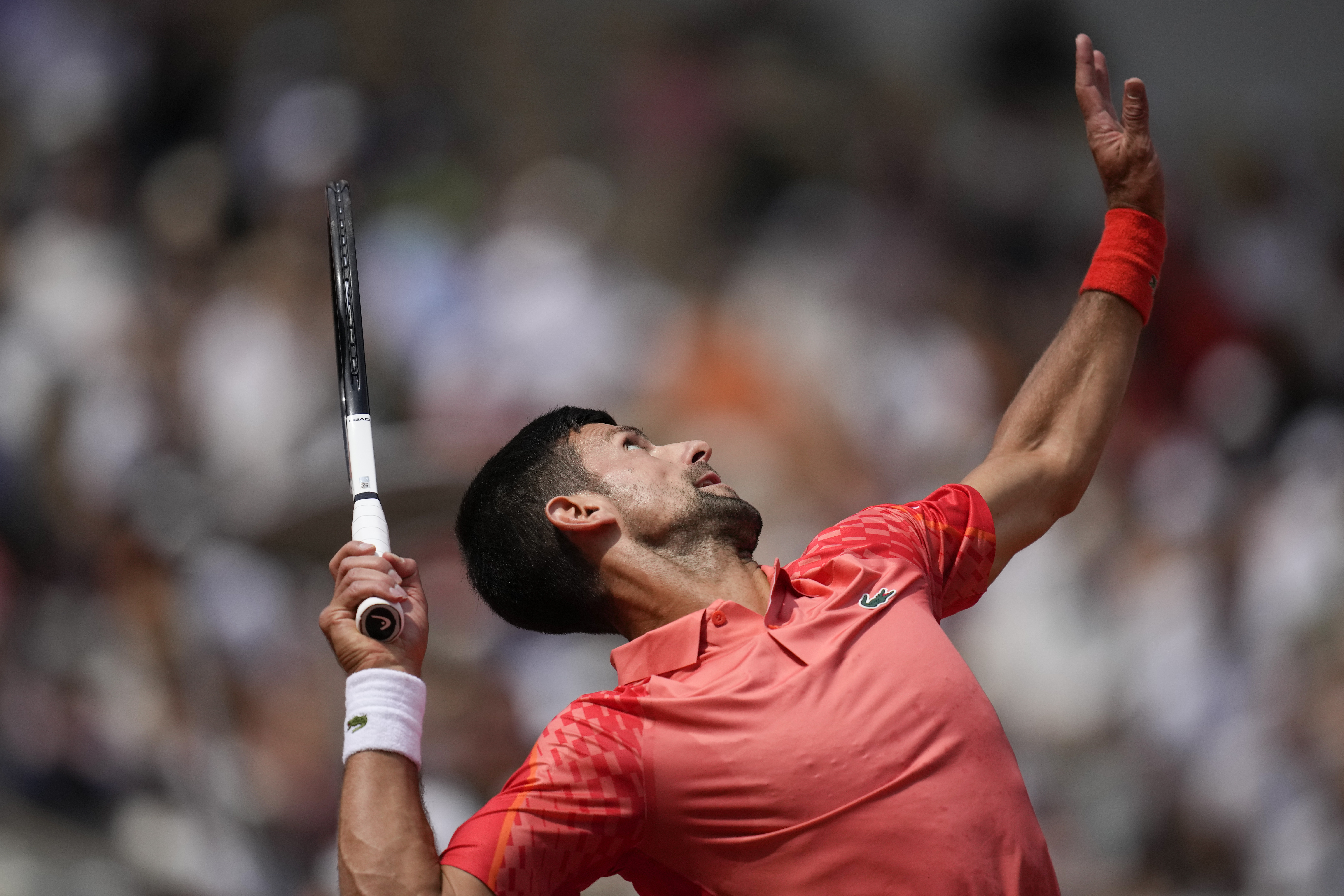 Serbia's Novak Djokovic serves against Spain's Carlos Alcaraz during their semifinal match of the French Open tennis tournament of the French Open tennis tournament at the Roland Garros stadium in Paris, Friday, June 9, 2023. (AP Photo/Christophe Ena)