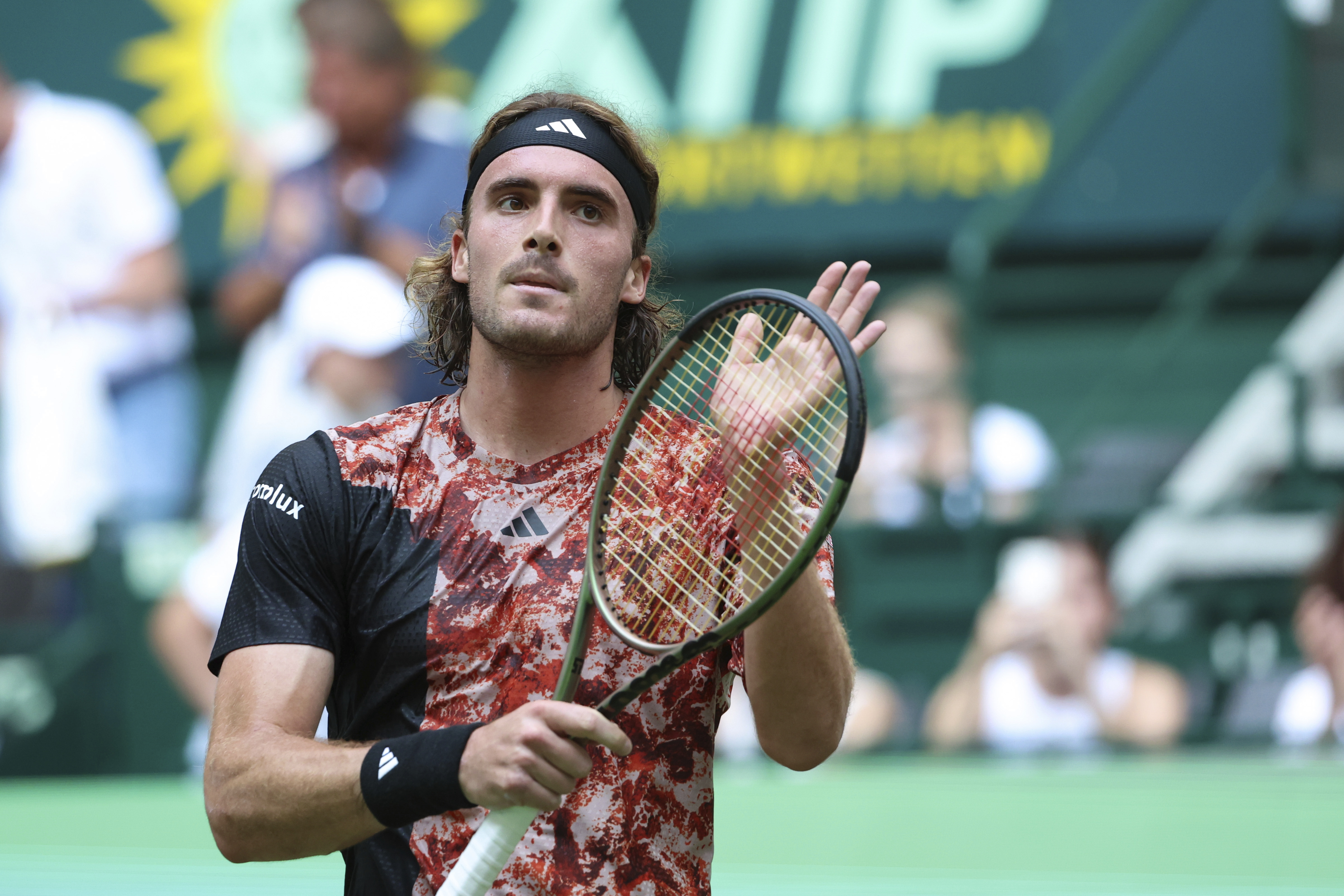 Stefanos Tsitsipas from Greece reacts after his first round tennis match against Gregoire Barrere from France at the Halle ATP Tour tennis tournament in Halle, Germany, Monday, June 19, 2023. (Friso Gentsch/dpa via AP)