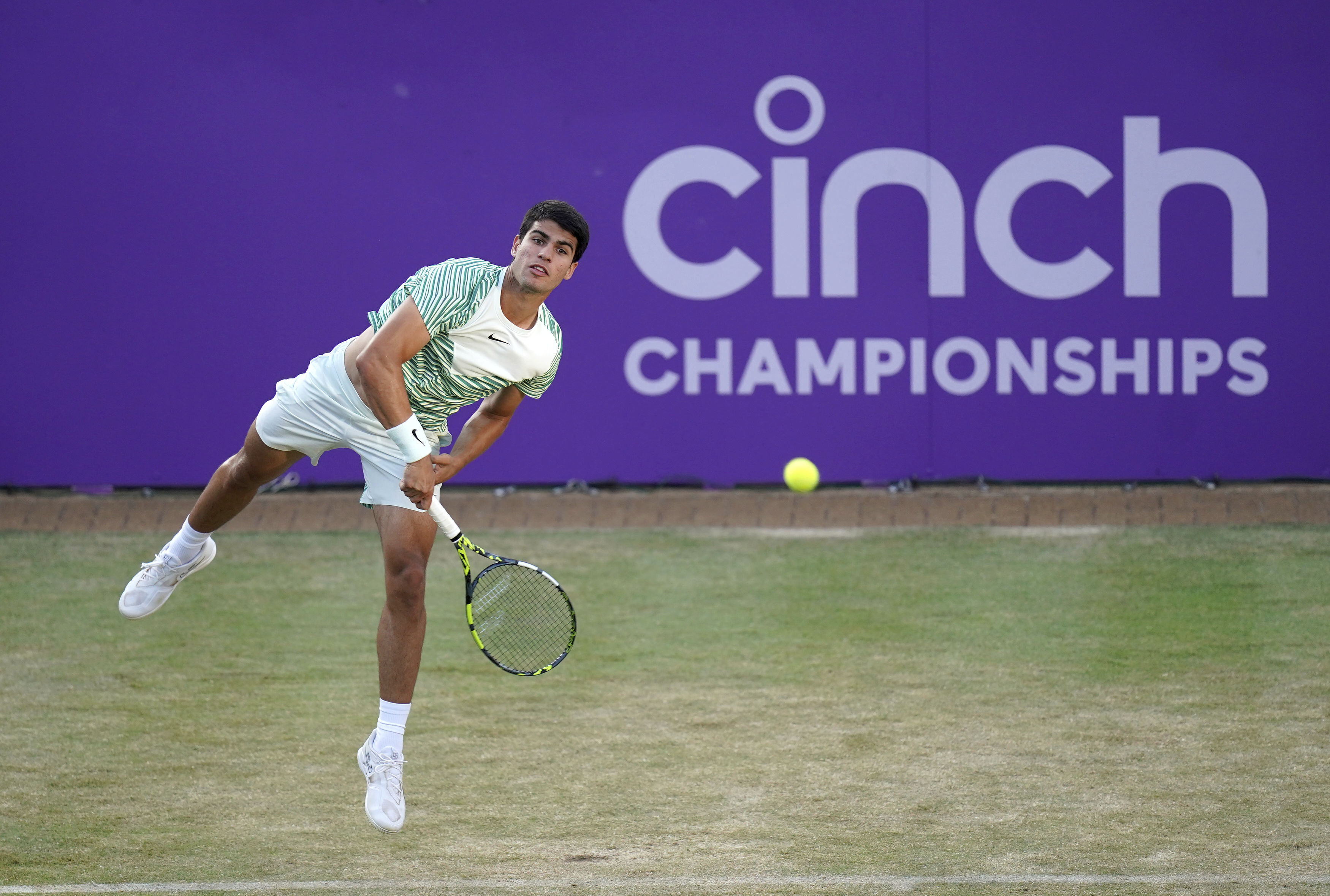 Spain's Carlos Alcaraz serves against Bulgaria's Grigor Dimitrov during their men's singles quarterfinal match on day five of the Queen's Club championship, in London, Friday June 23, 2023. (Adam Davy/PA via AP)