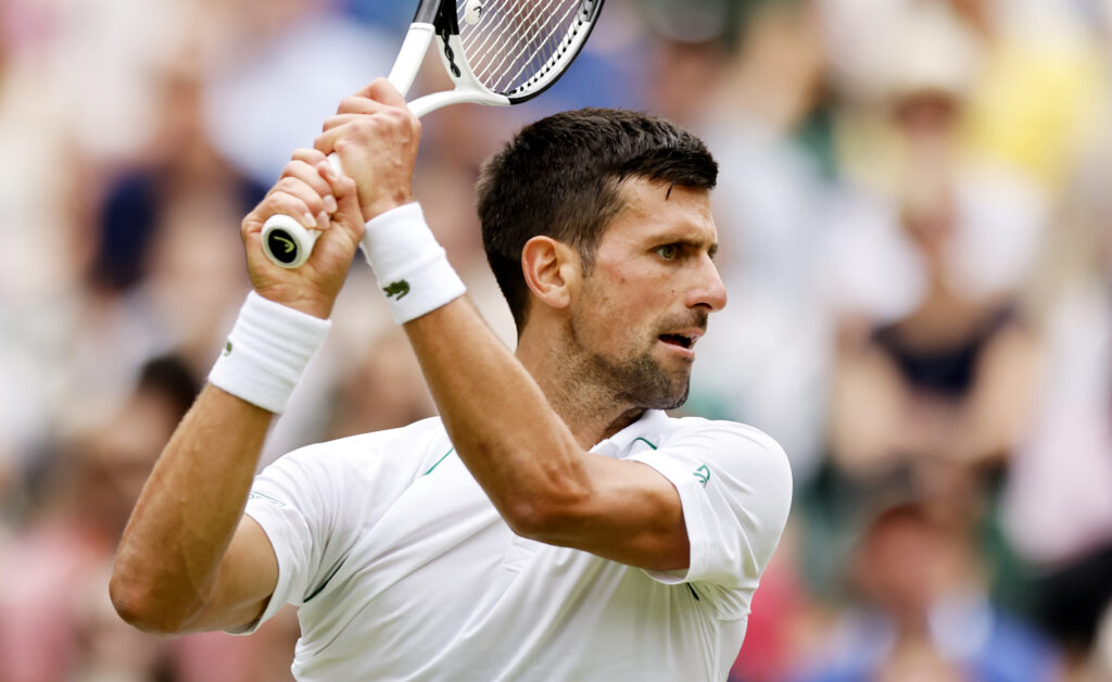 epa10053279 Novak Djokovic of Serbia in action in the men's quarter final match against Jannik Sinner of Italy at the Wimbledon Championships, in Wimbledon, Britain, 05 July 2022.  EPA-EFE/TOLGA AKMEN   EDITORIAL USE ONLY