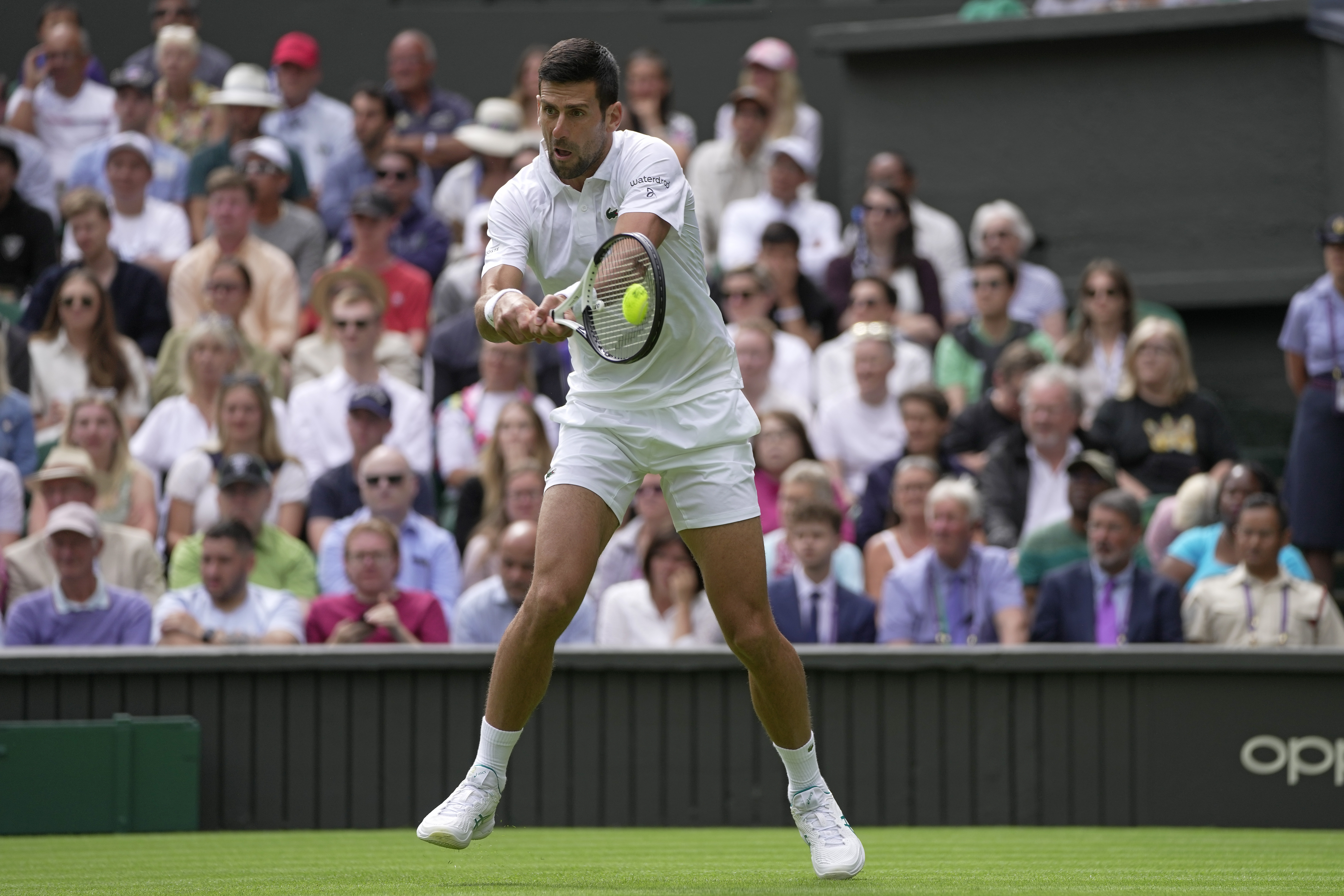 Serbia's Novak Djokovic returns to Argentina's Pedro Cachin during their first round men's singles match on day one of the Wimbledon tennis championships in London, Monday, July 3, 2023. (AP Photo/Kin Cheung)