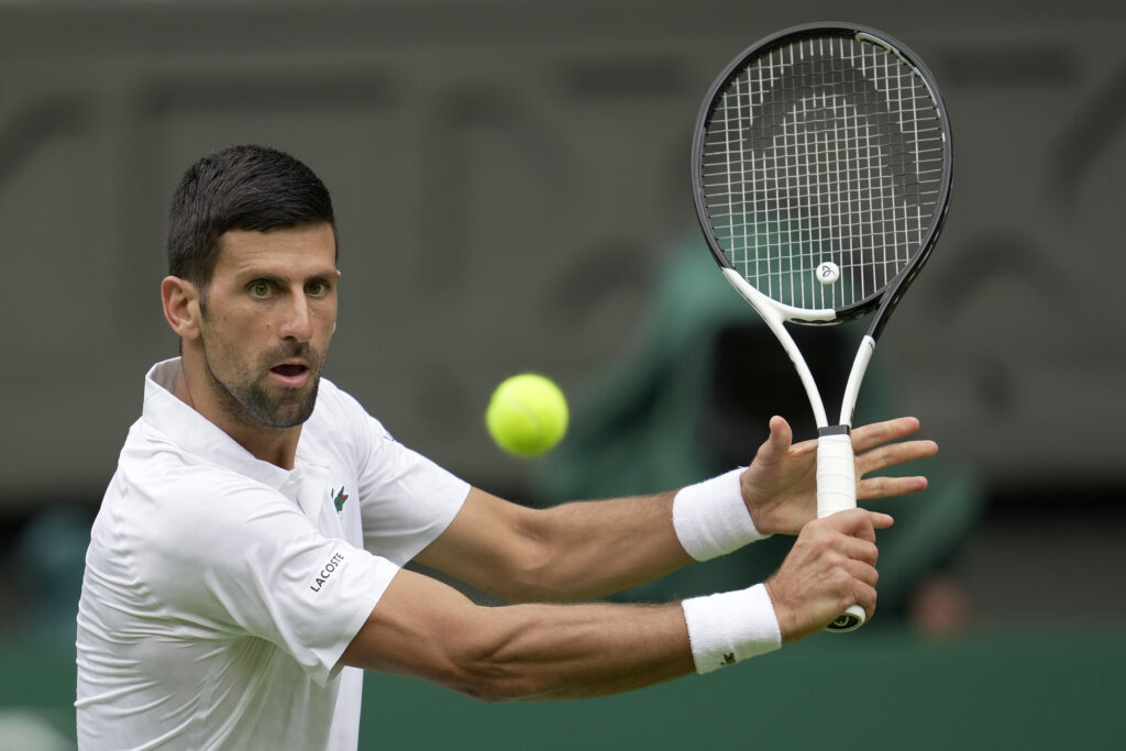 Serbia's Novak Djokovic returns to Argentina's Pedro Cachin during their first round men's singles match on day one of the Wimbledon tennis championships in London, Monday, July 3, 2023. (AP Photo/Kin Cheung)