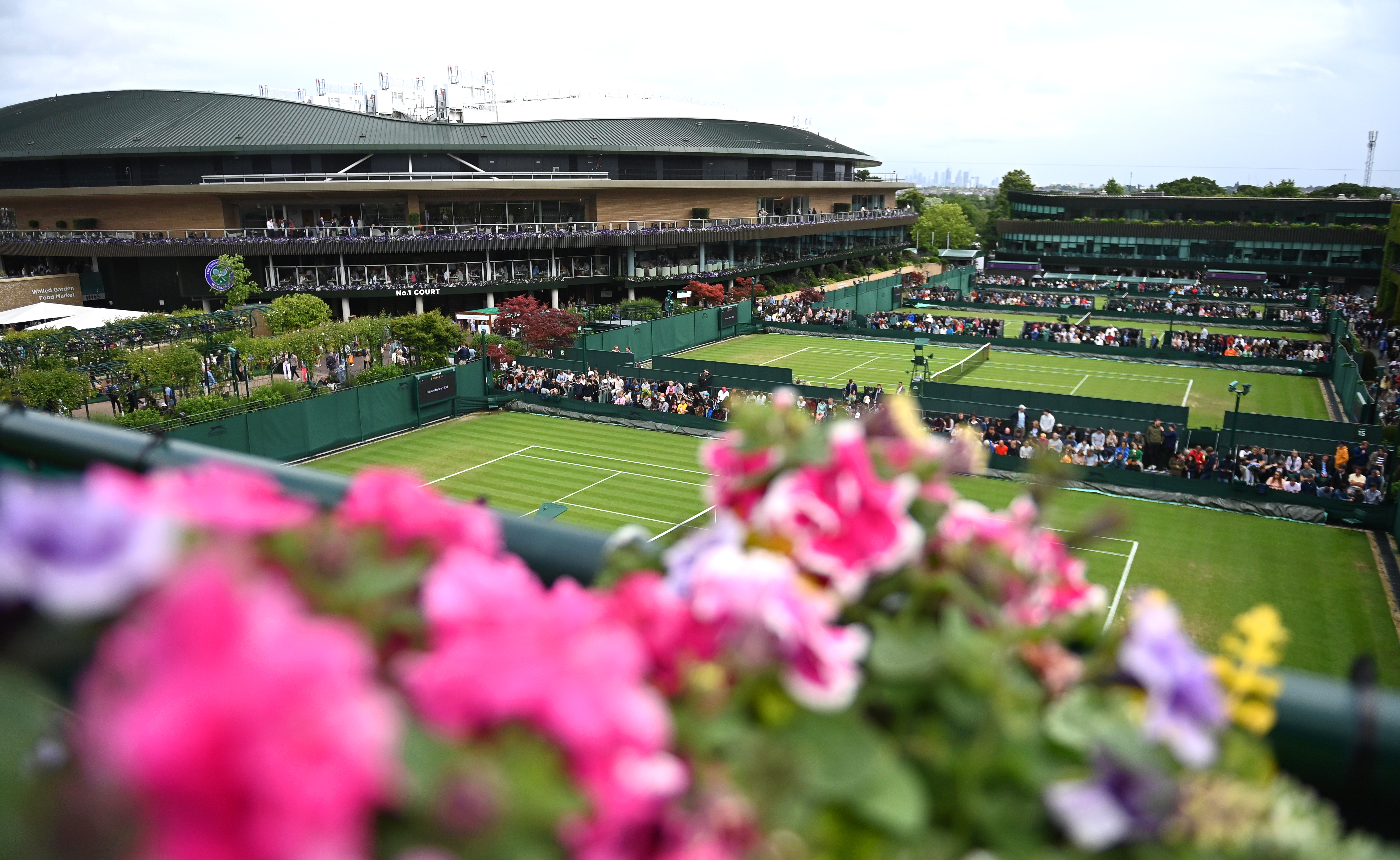 epa10040800 General view of court No.1 (L) as matches are temporarily suspended due to rain on the third day at the Wimbledon Championships in Wimbledon, Britain, 29 June 2022.  EPA-EFE/NEIL HALL   EDITORIAL USE ONLY