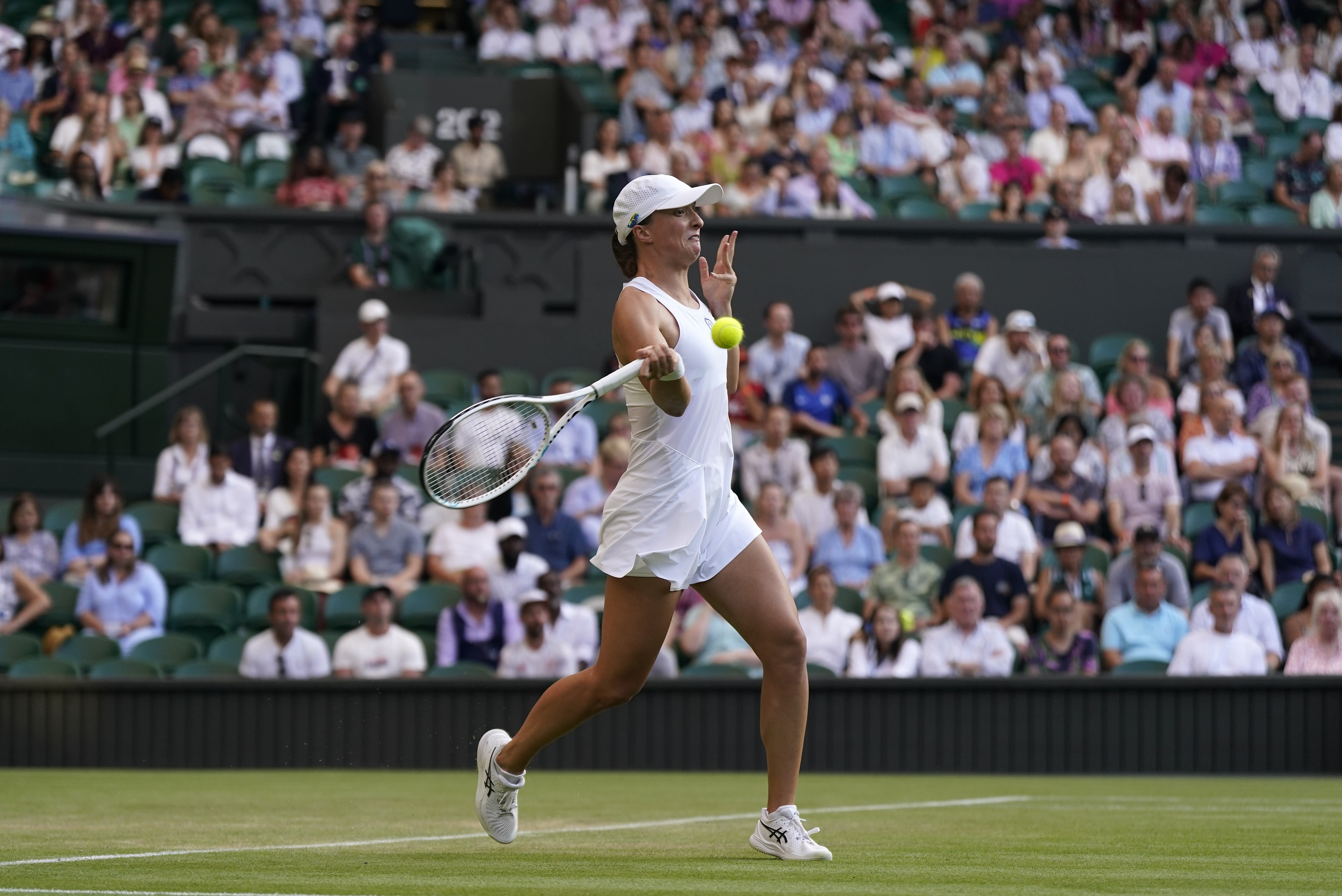 Poland's Iga Swiatek returns to Croatia's Petra Martic in a women's singles match on day five of the Wimbledon tennis championships in London, Friday, July 7, 2023. (AP Photo/Alberto Pezzali)