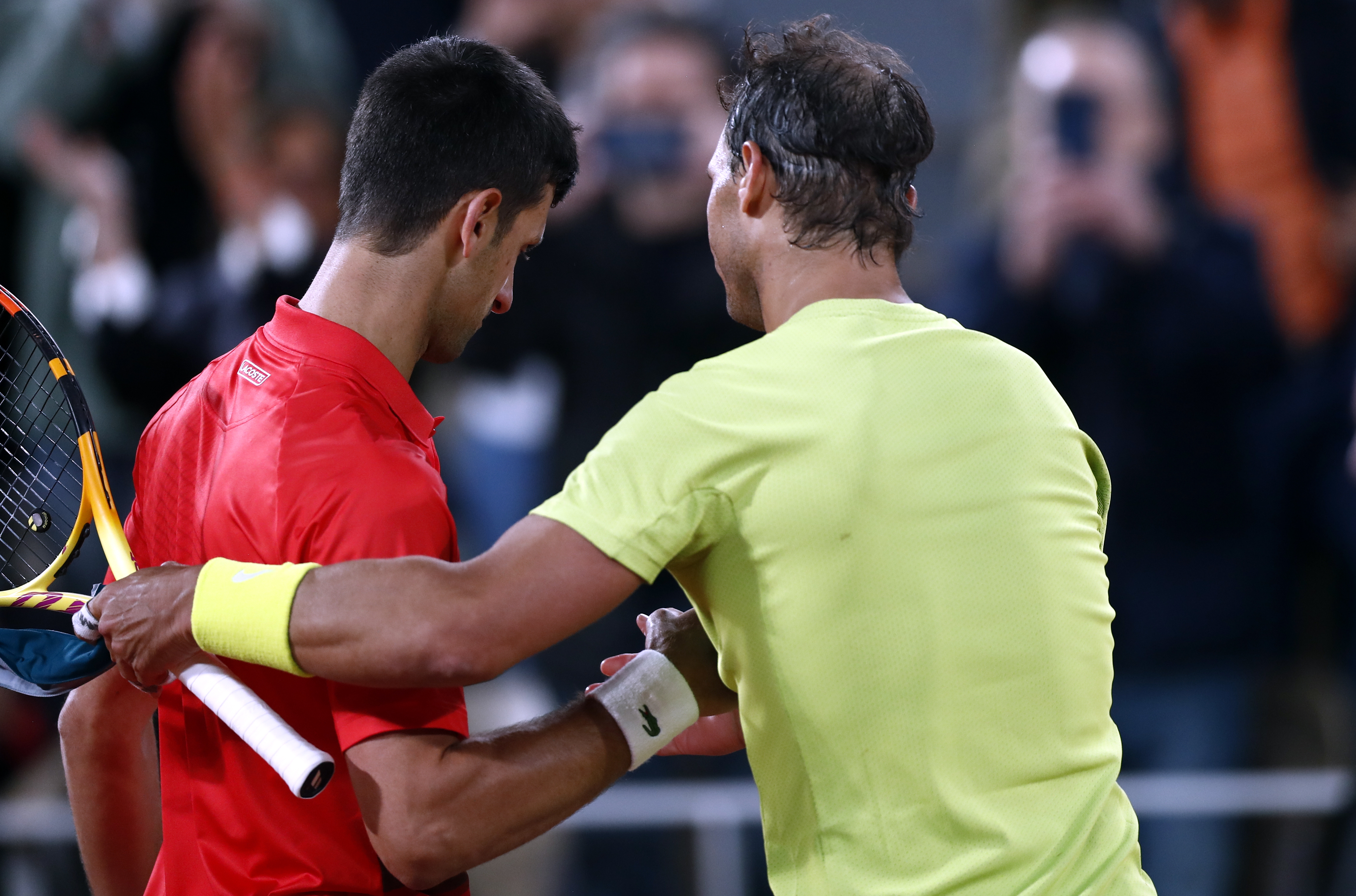 epa09988867 Rafael Nadal of Spain (R) reacts with Novak Djokovic of Serbia after winning their men?s quarterfinal match during the French Open tennis tournament at Roland ?Garros in Paris, France, 01 June 2022.  EPA-EFE/MOHAMMED BADRA