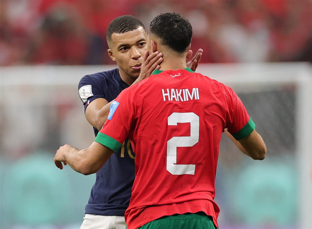 epa10366307 Kylian Mbappe (L) of France and Achraf Hakimi of Morocco react after the final whistle of the FIFA World Cup 2022 semi final between France and Morocco at Al Bayt Stadium in Al Khor, Qatar, 14 December 2022.  EPA-EFE/Friedemann Vogel