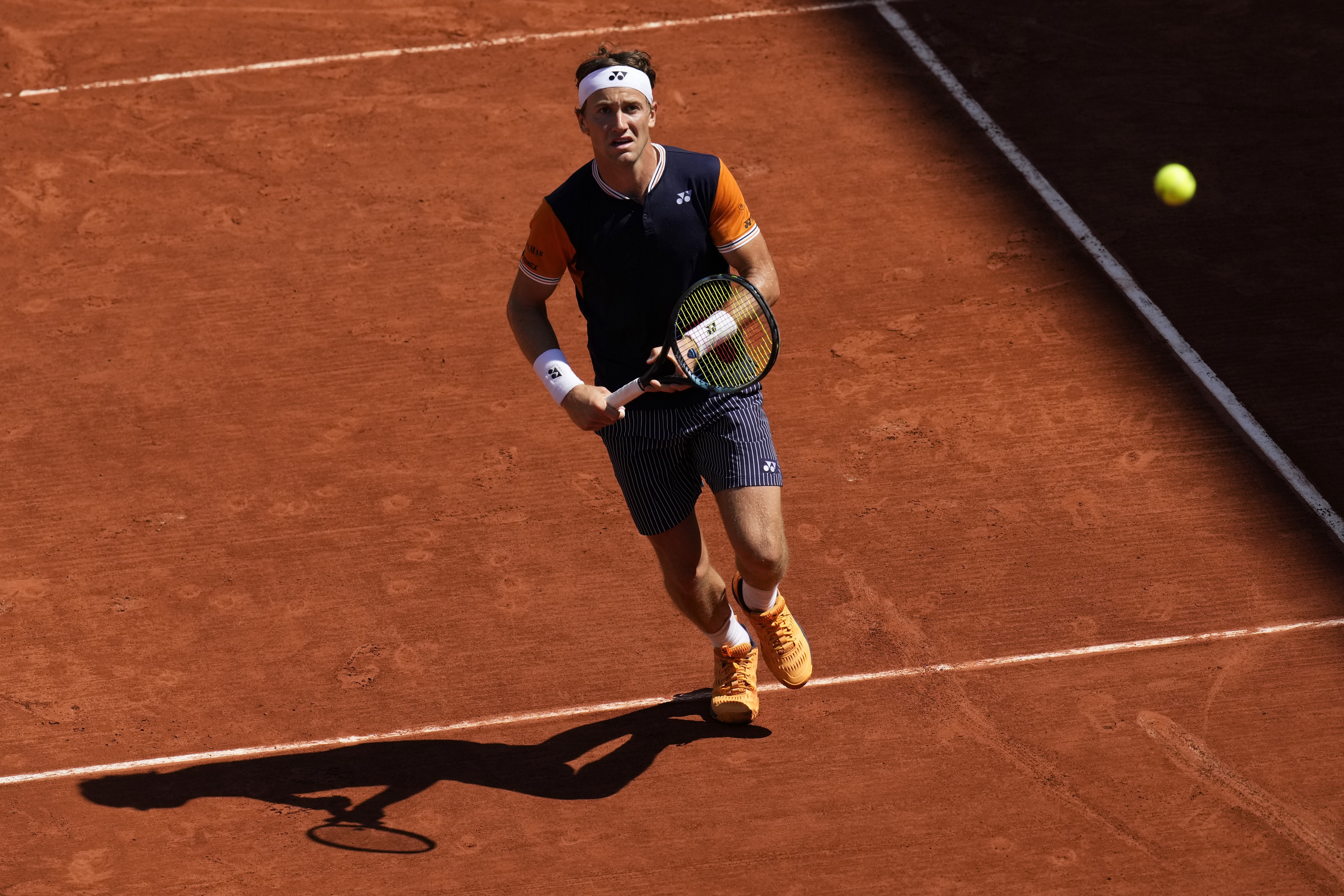 Norway's Casper Ruud eyes the ball as he plays a shot against China's Zhang Zhizhen during their third round match of the French Open tennis tournament at the Roland Garros stadium in Paris, Saturday, June 3, 2023. (AP Photo/Christophe Ena)