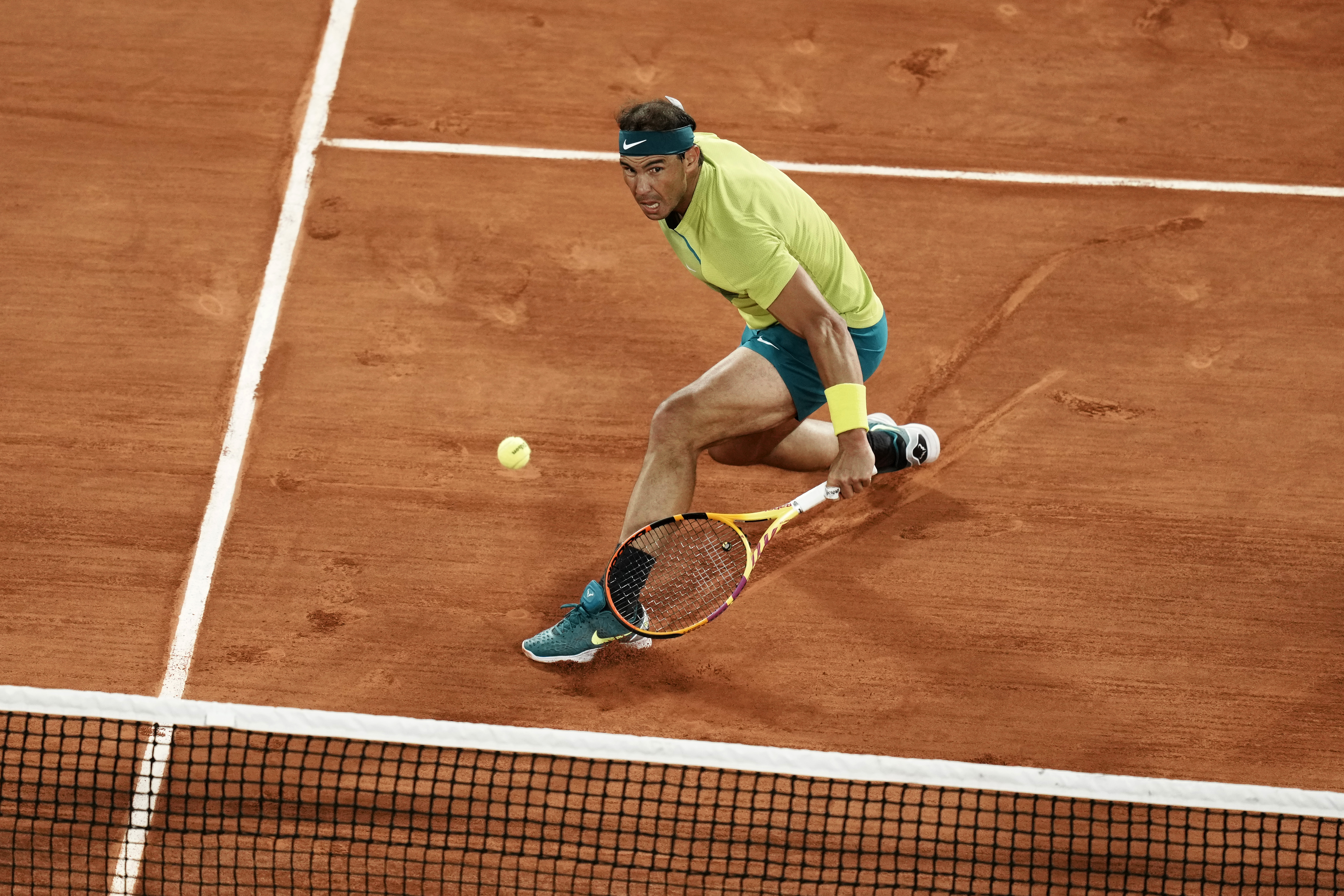 Spain's Rafael Nadal returns the ball to Serbia's Novak Djokovic during their quarterfinal match of the French Open tennis tournament at the Roland Garros stadium Tuesday, May 31, 2022 in Paris. (AP Photo/Thibault Camus)