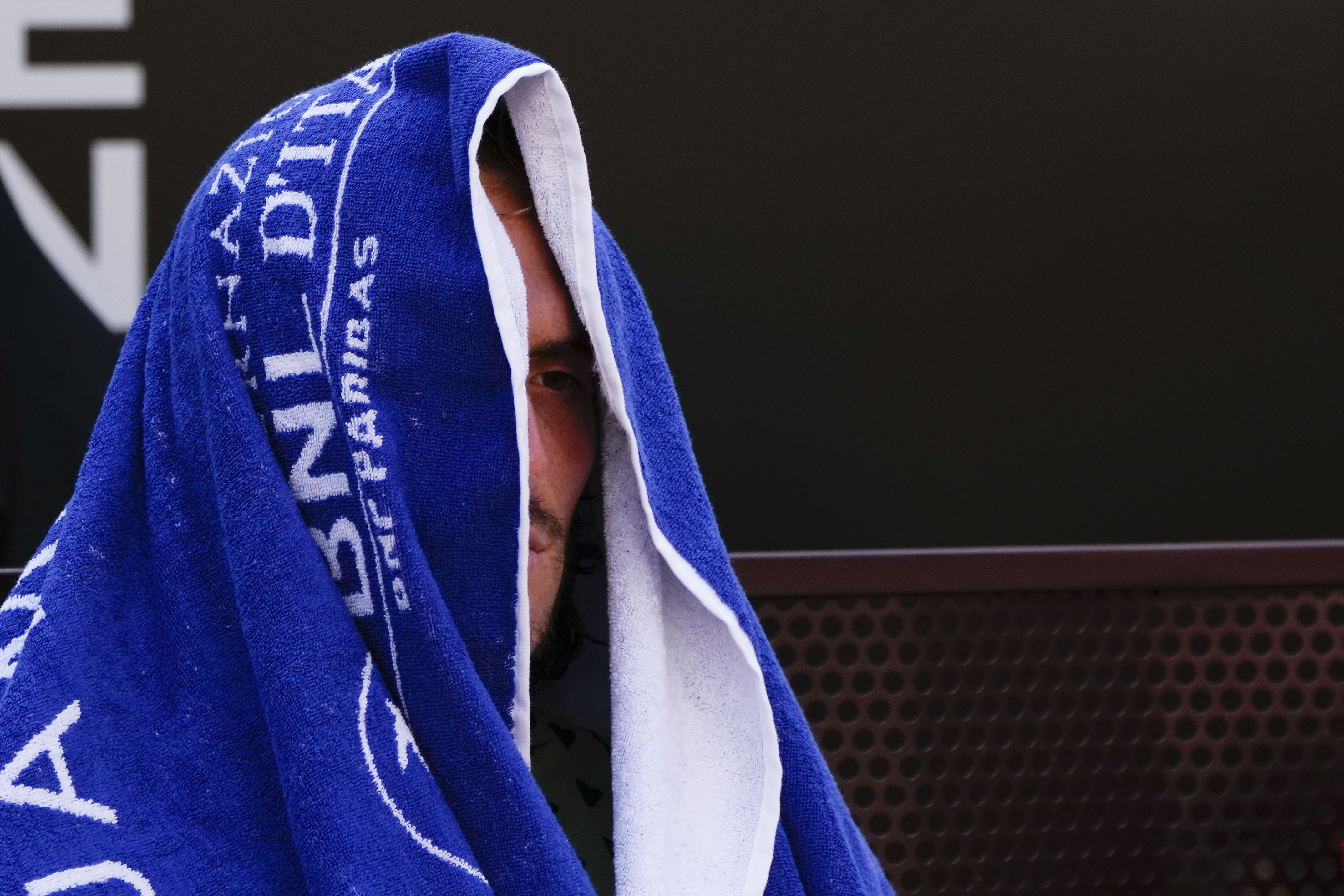 Greece's Stefanos Tsitsipas sits on a bench at the end of the final match against Serbia's Novak Djokovic at the Italian Open tennis tournament, in Rome, Sunday, May 15, 2022. (AP Photo/Alessandra Tarantino)