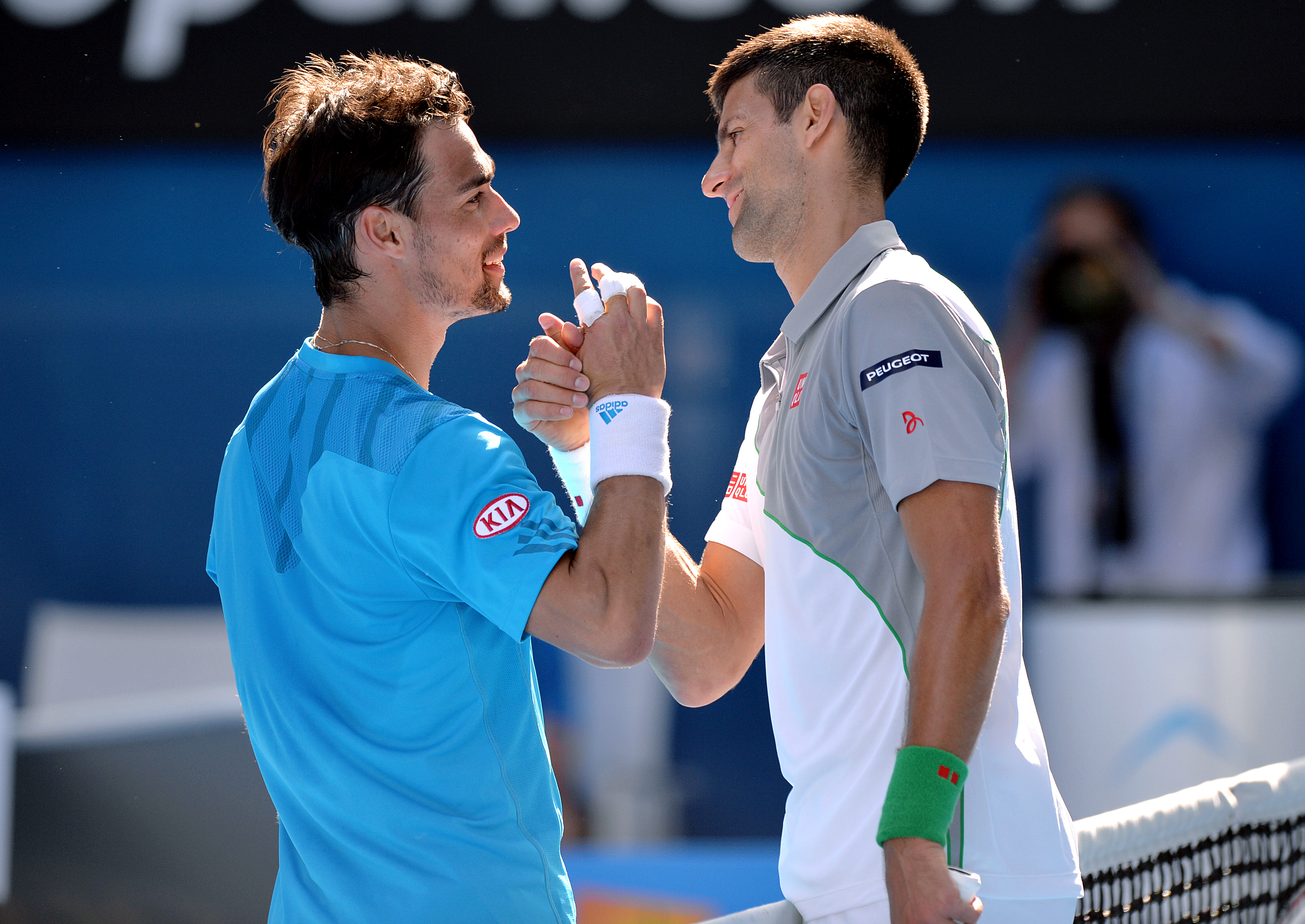 epa04030046 Novak Djokovic of Serbia (R) meets Fabio Fognini of Italy at the net after their round four match at the Australian Open tennis tournament in Melbourne, Australia, 19 January 2014.  EPA/JOE CASTRO AUSTRALIA AND NEW ZEALAND OUT