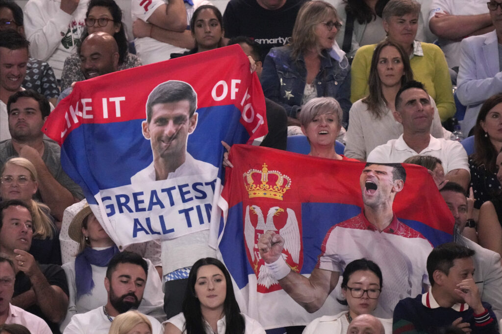 Supporters of Novak Djokovic of Serbia hold up banners during his match against Stefanos Tsitsipas of Greece in the men's singles final at the Australian Open tennis championship in Melbourne, Australia, Sunday, Jan. 29, 2023. (AP Photo/Dita Alangkara)