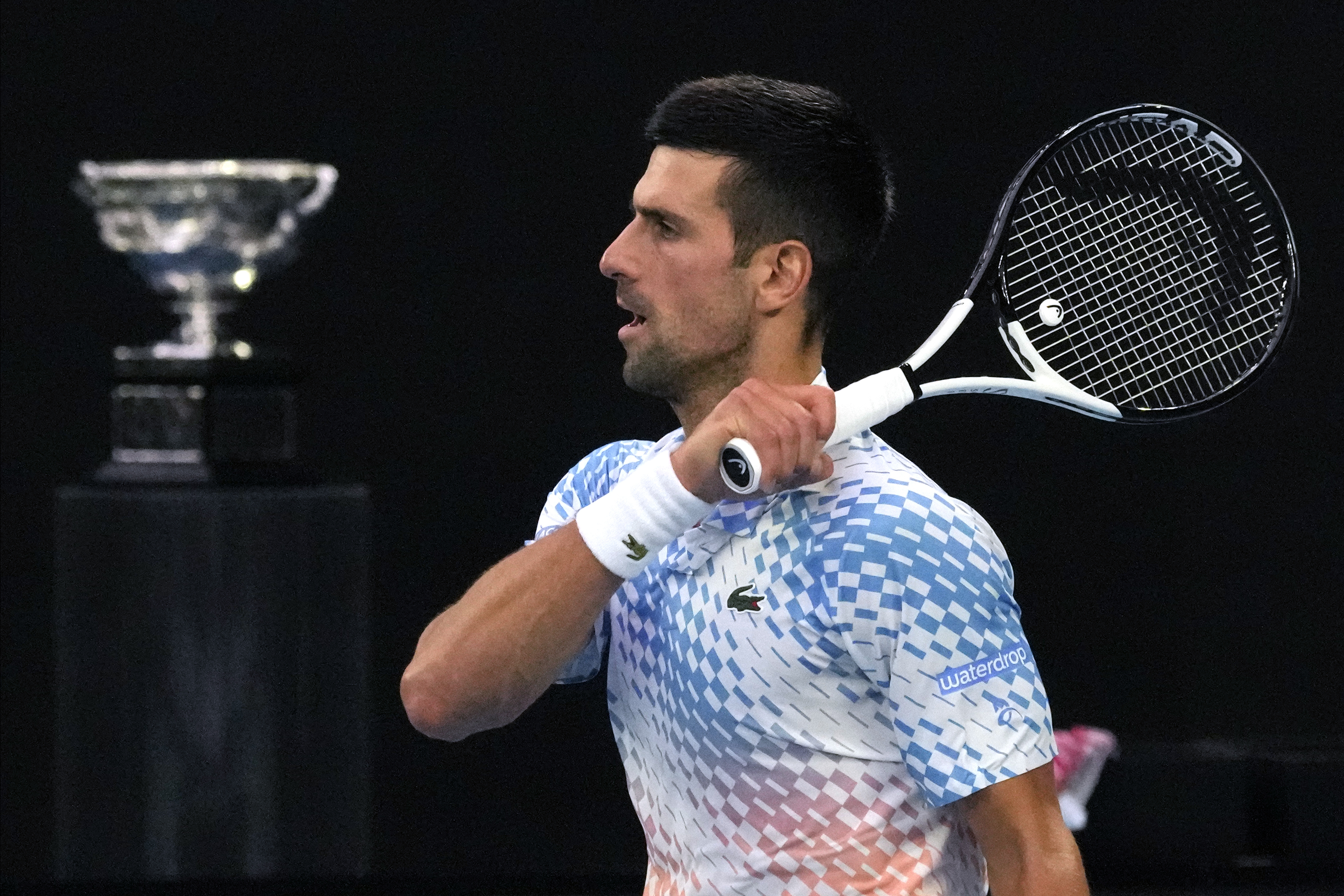 Novak Djokovic of Serbia plays a forehand return to Stefanos Tsitsipas of Greece during the men's singles final at the Australian Open tennis championship in Melbourne, Australia, Sunday, Jan. 29, 2023. (AP Photo/Aaron Favila)