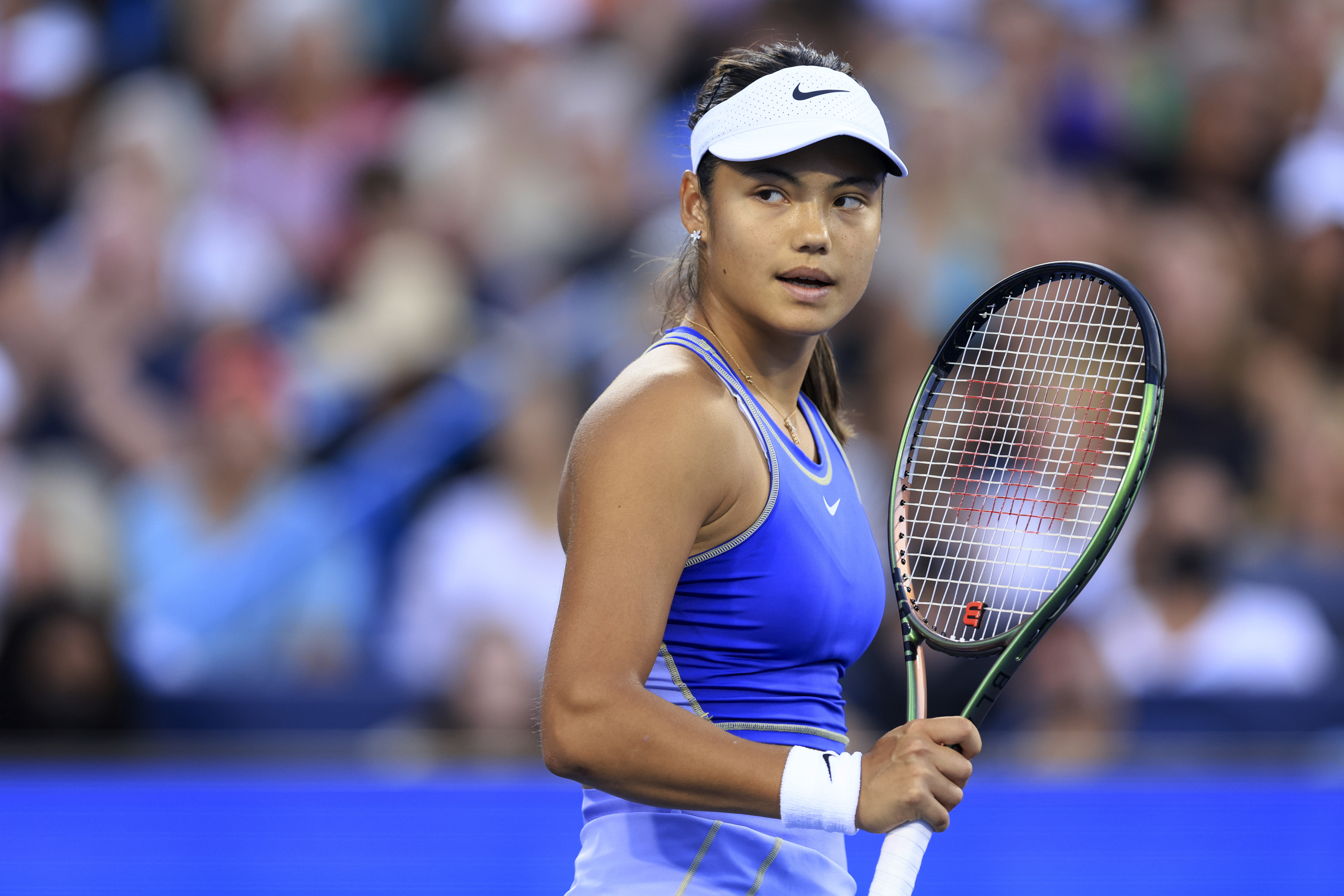 Emma Raducanu, of Britain, reacts after winning a point against Serena Williams, of the United States, during the Western &amp; Southern Open tennis tournament Tuesday, Aug. 16, 2022, in Mason, Ohio. Raducanu won 6-4, 6-0. (AP Photo/Aaron Doster)