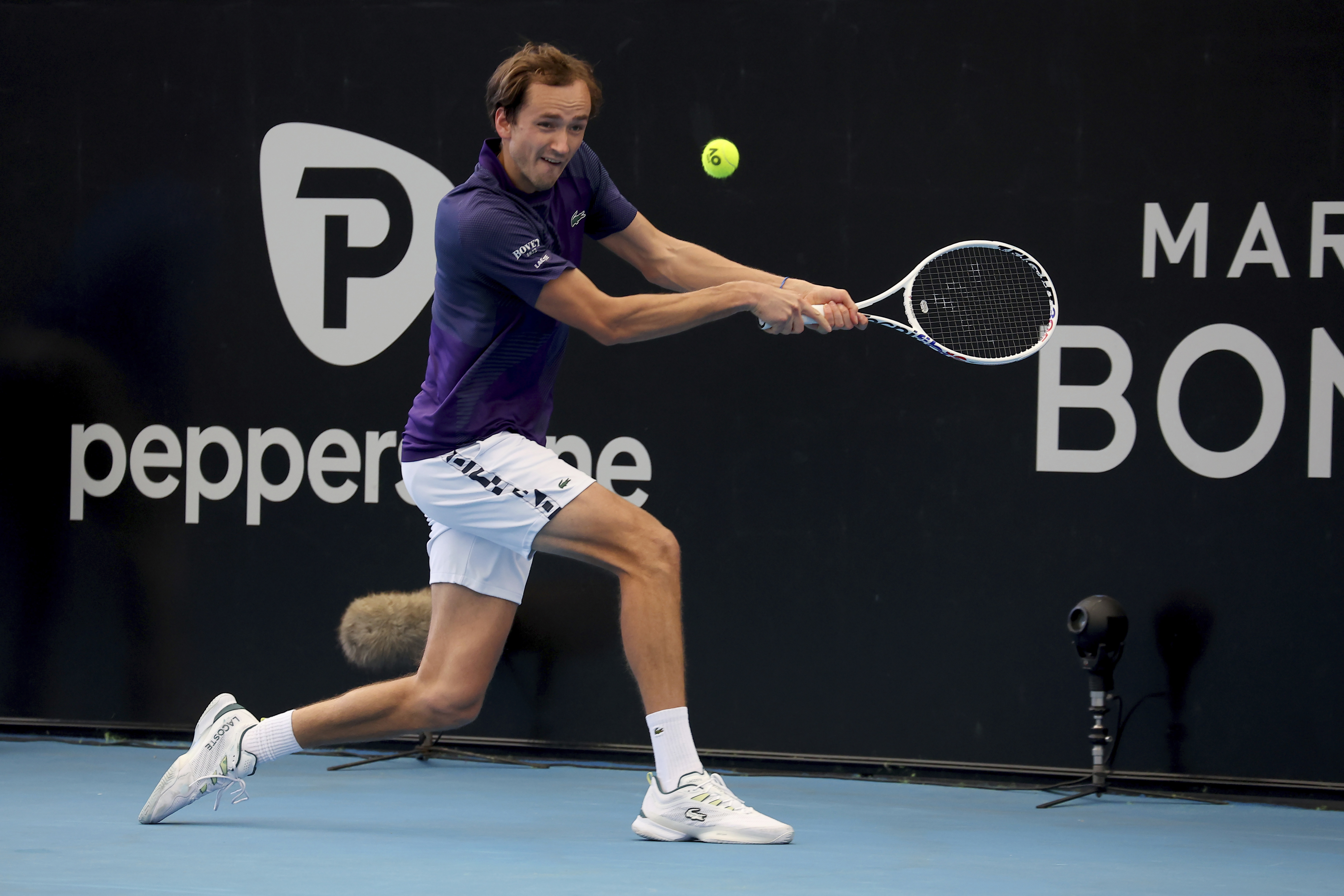 Russia's Daniil Medvedev makes a backhand return to Russia's Karen Khachanov during their Quarter final match at the Adelaide International Tennis tournament in Adelaide, Australia, Friday, Jan. 6, 2023. (AP Photo/Kelly Barnes)