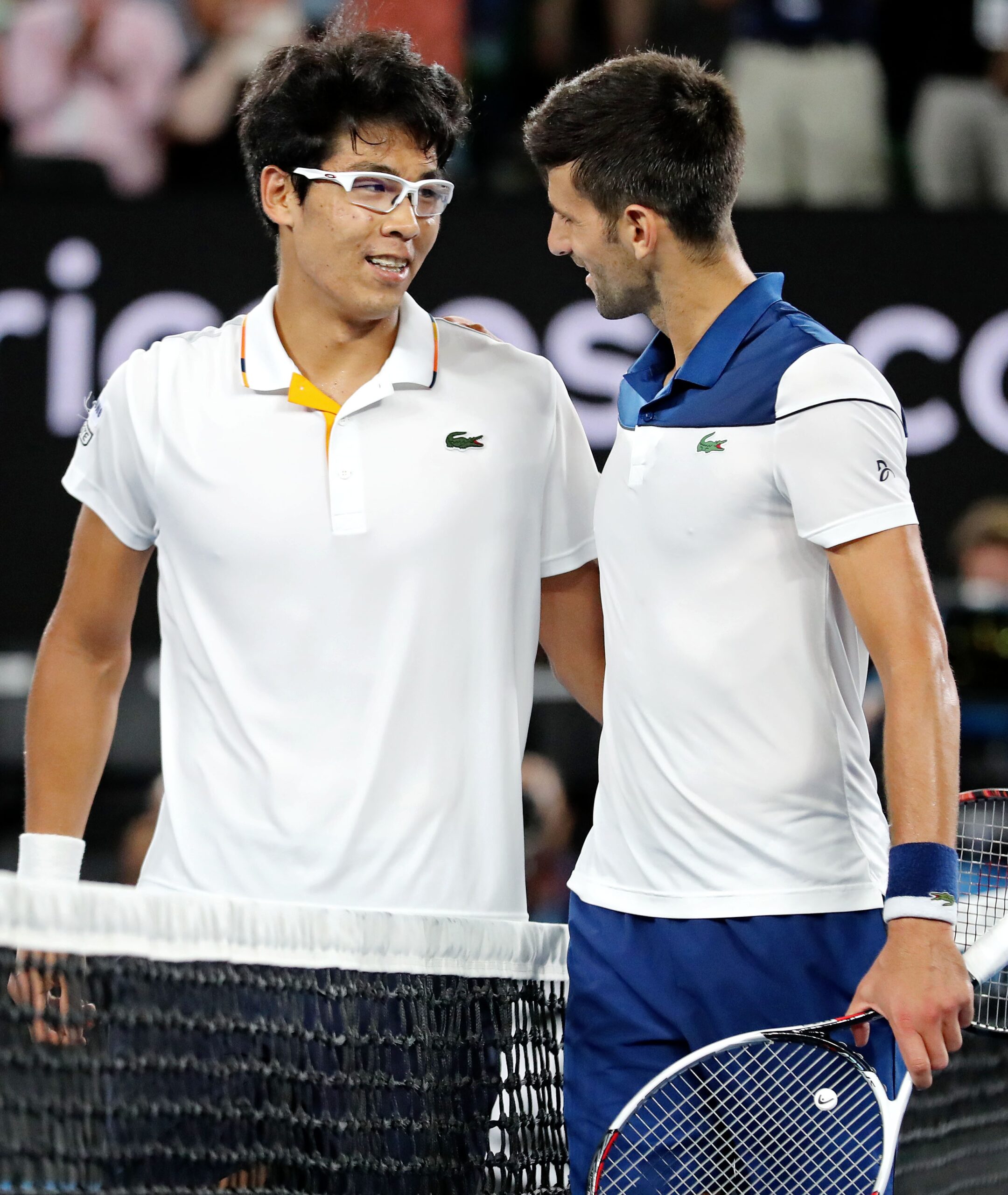 epa06464512 Chung Hyeon (L) of South Korea and Novak Djokovic (R) of Serbia greet each other after their fourth round match at the Australian Open Grand Slam tennis tournament in Melbourne, Australia, 22 January 2018.  EPA-EFE/MAST IRHAM