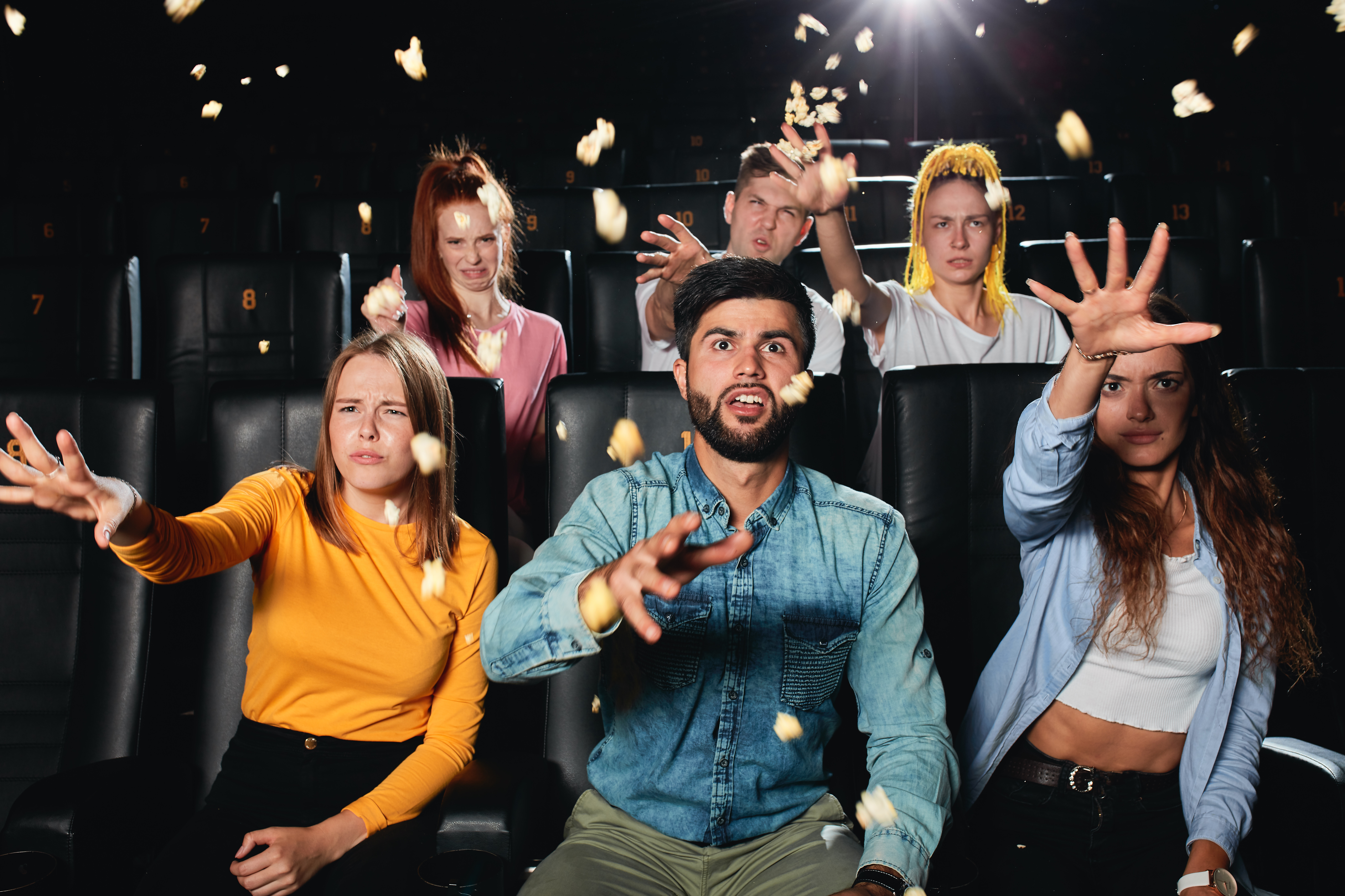 Dissatisfied,Multi,Racial,Friends,Watching,Film,,Throwing,Popcorn,To,The