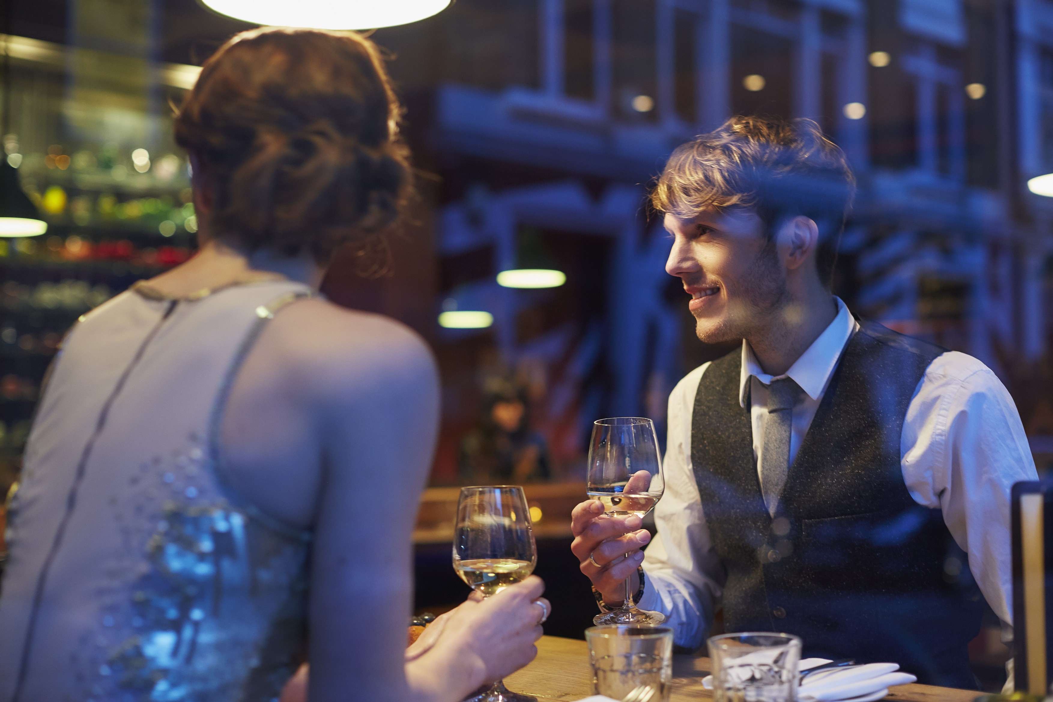 Couple holding wine glasses in restaurant