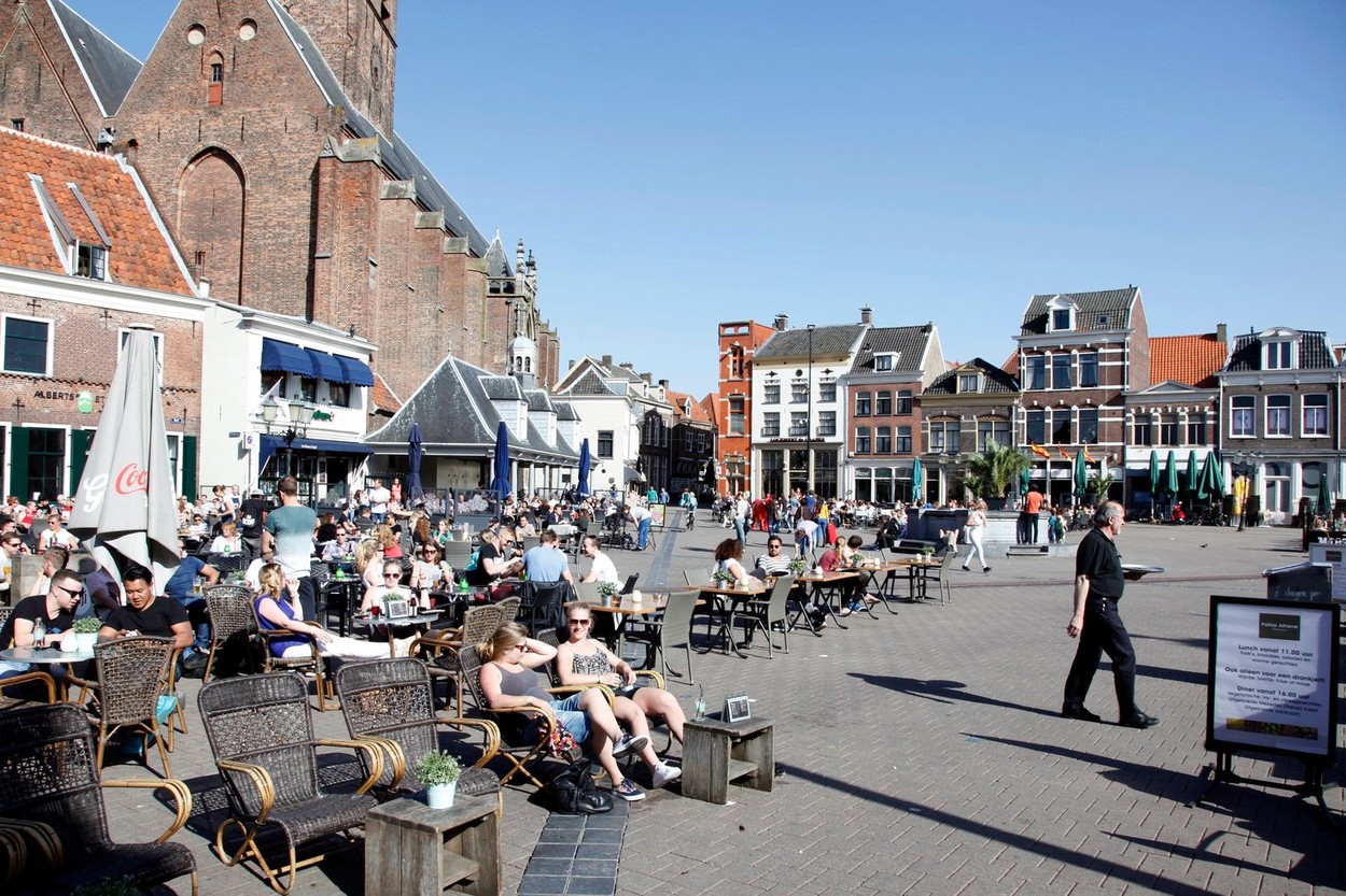 people enjoy the spring sunshine in the old city of amersfoort
