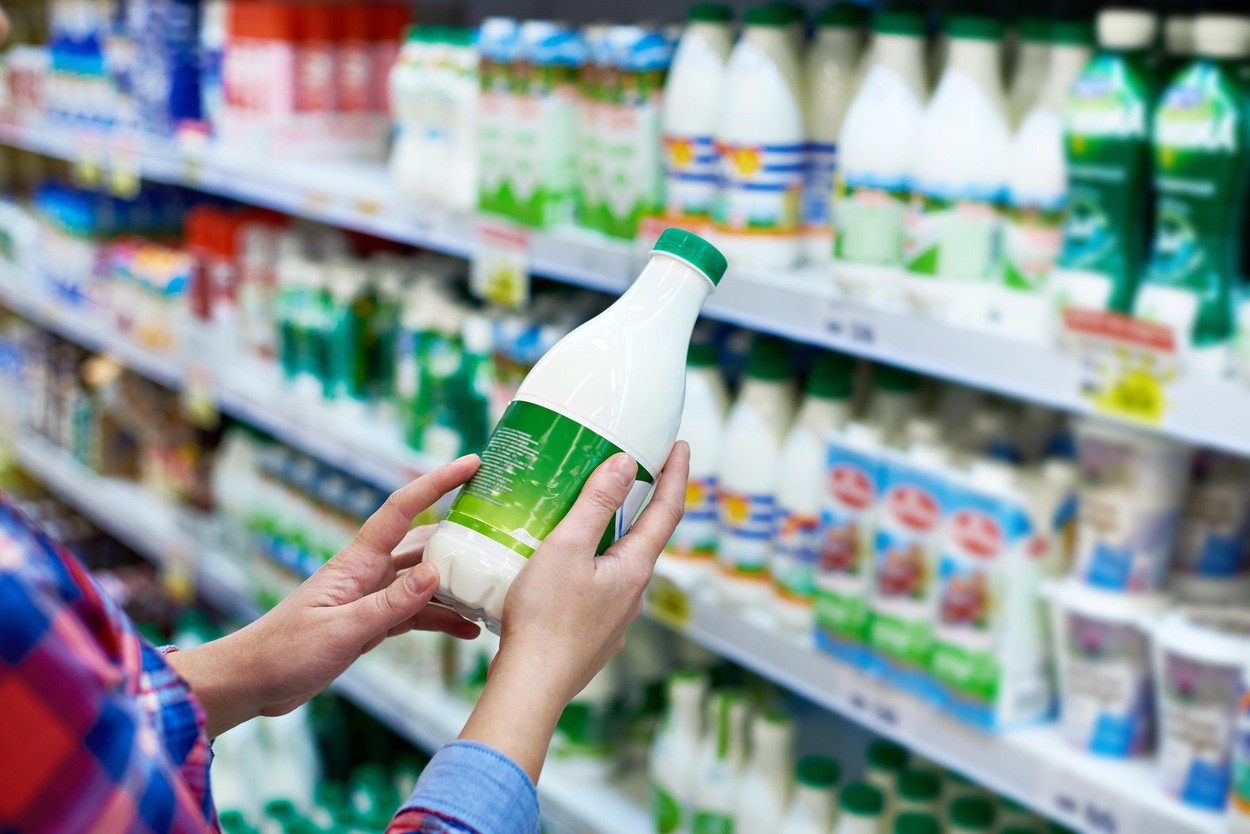 Woman shopping milk in grocery store
