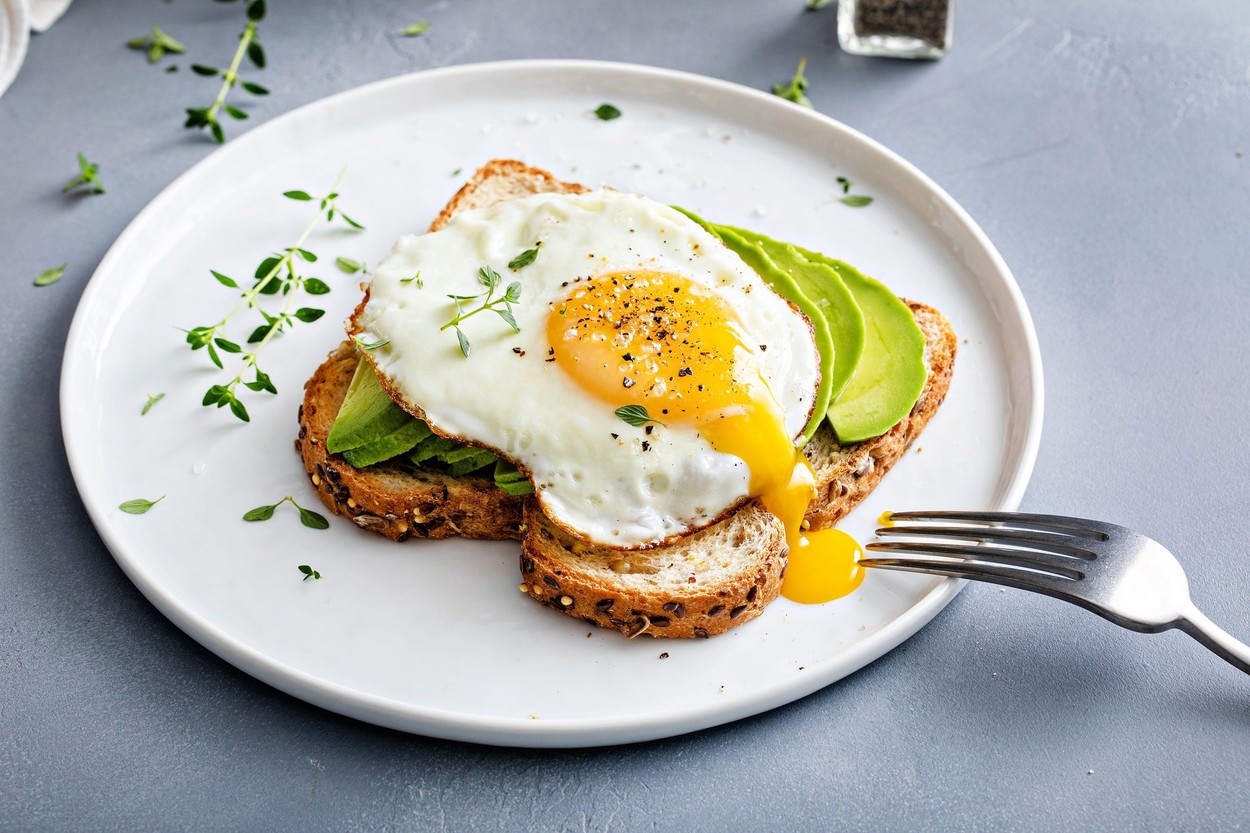 Avocado toast on a toasted multigrain bread with a fried egg on top and running yolk,Image: 714045488, License: Royalty-free, Restrictions: , Model Release: no, Credit line: Elena Veselova / Alamy / Alamy / Profimedia