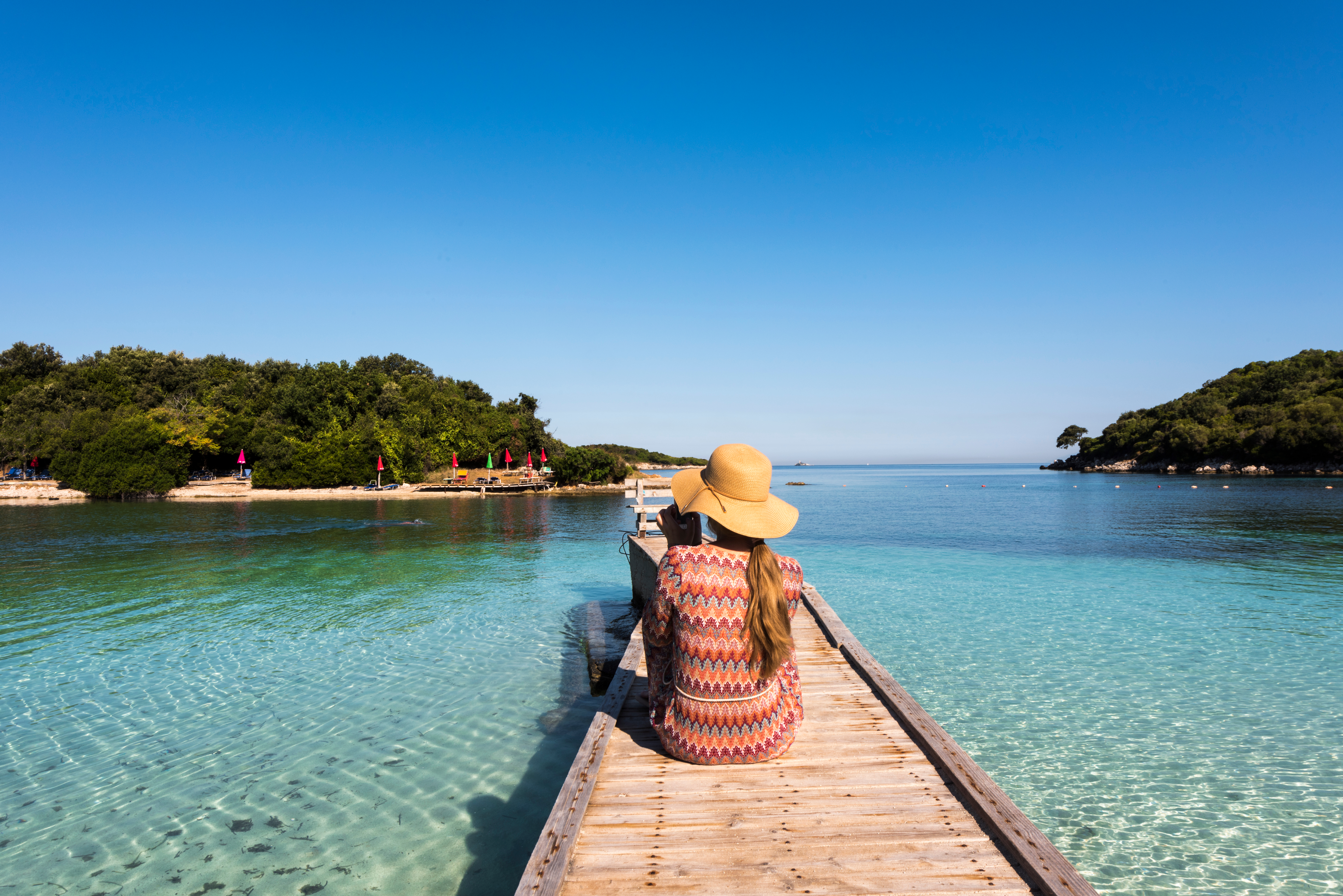 Ksamil,Beach,-,Woman,With,Straw,Hat,Sitting,On,A