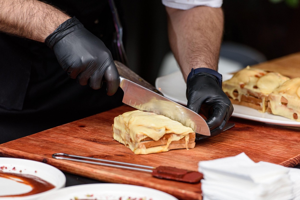 Francesinha, traditional Portuguese sandwich originally from Porto. National cuisine concept. the chef prepares a dish at restaurant