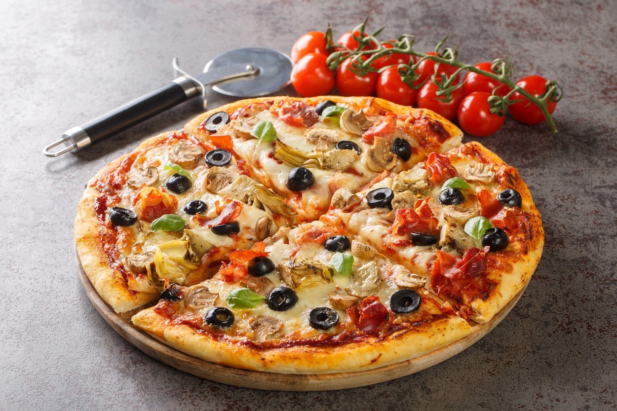 Close up of traditional Capricciosa in Italian restaurant. Front view. Italian pizza concept. Horizontal