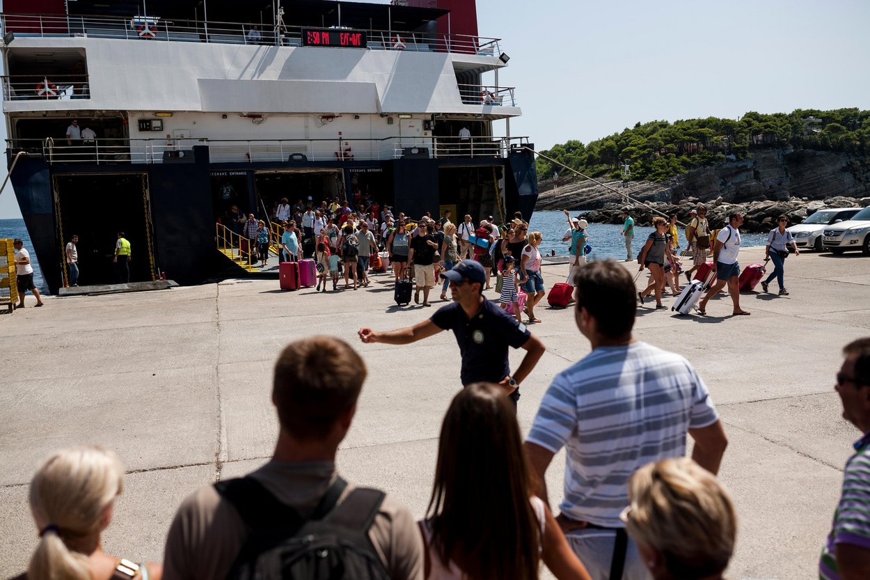 Travelers wait at the Alonnisos port to depart to Volos in Greece on August 21, 2014.