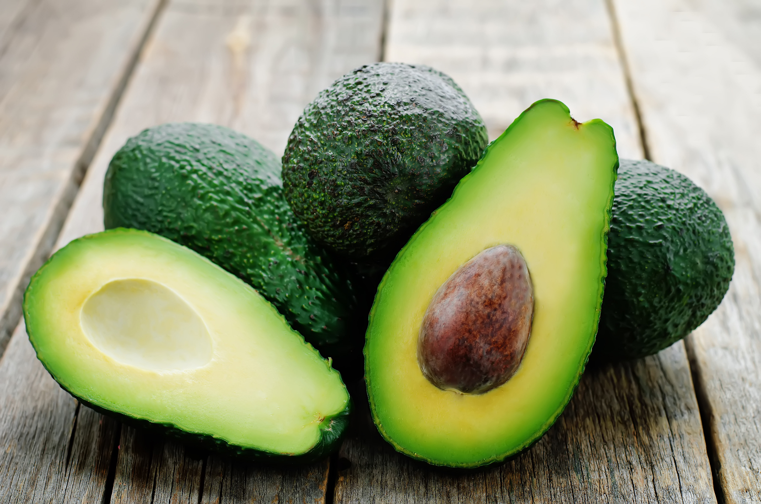 avocado on a dark wood background. tinting. selective focus avokado