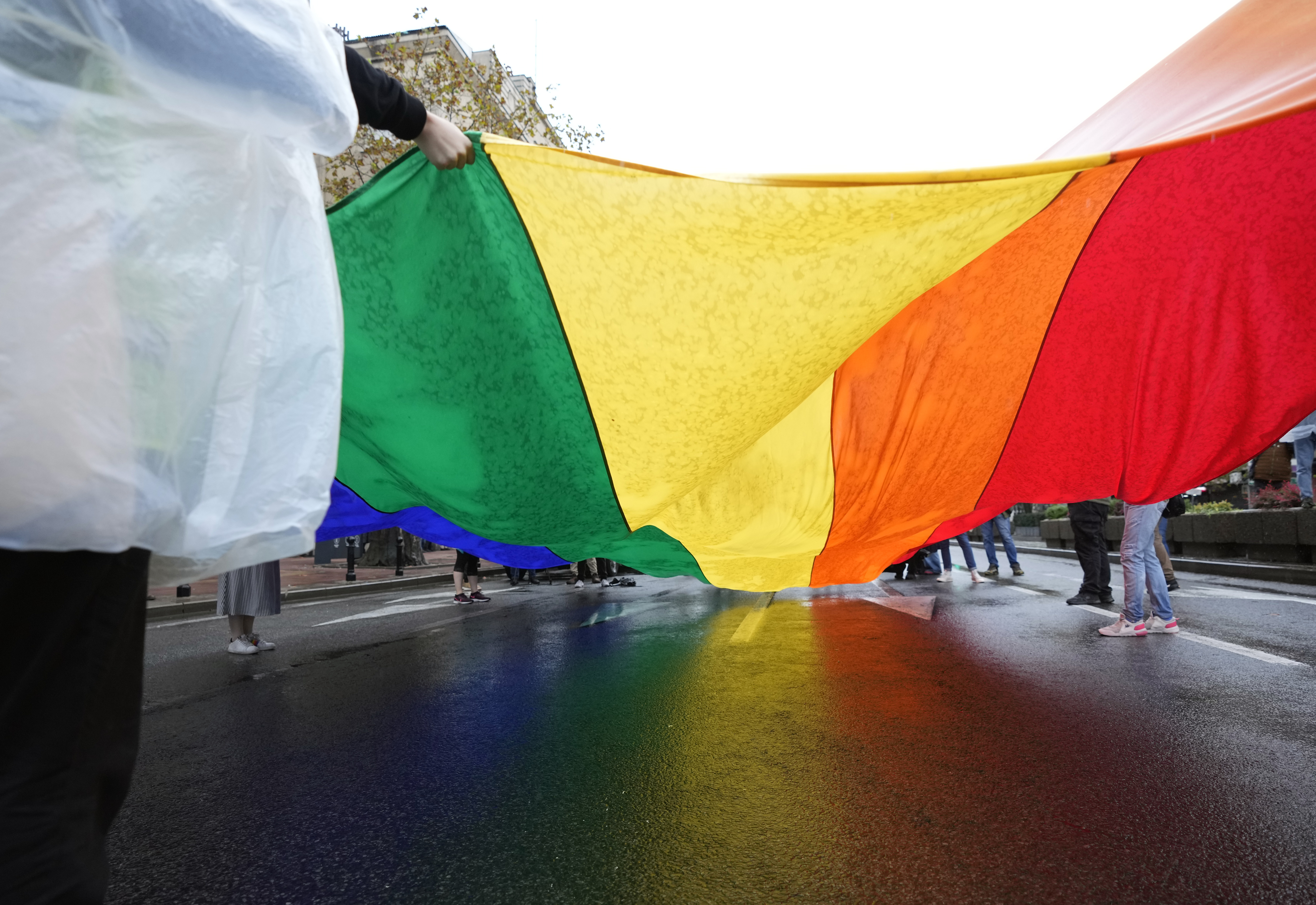 Participants carry a large rainbow flag during the European LGBTQ pride march in Belgrade, Serbia, Saturday, Sept. 17, 2022. Serbian police have banned Saturday's parade, citing a risk of clashes with far-right activists. (AP Photo/Darko Vojinovic)
