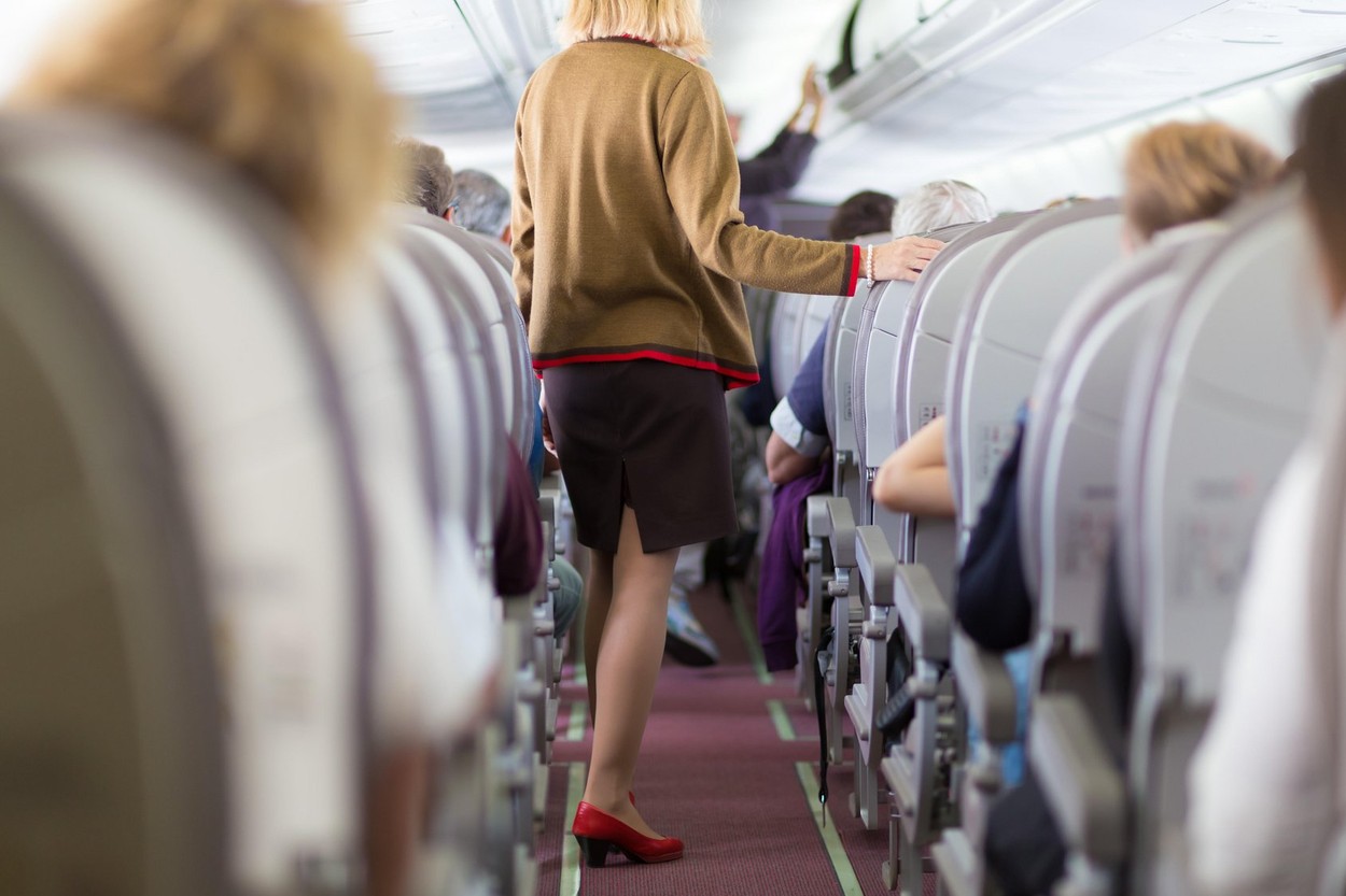 Interior of airplane with passengers on seats and stewardess walking the aisle.,Image: 207778516, License: Royalty-free, Restrictions: , Model Release: no, Credit line: Matej Kastelic / Alamy / Alamy / Profimedia