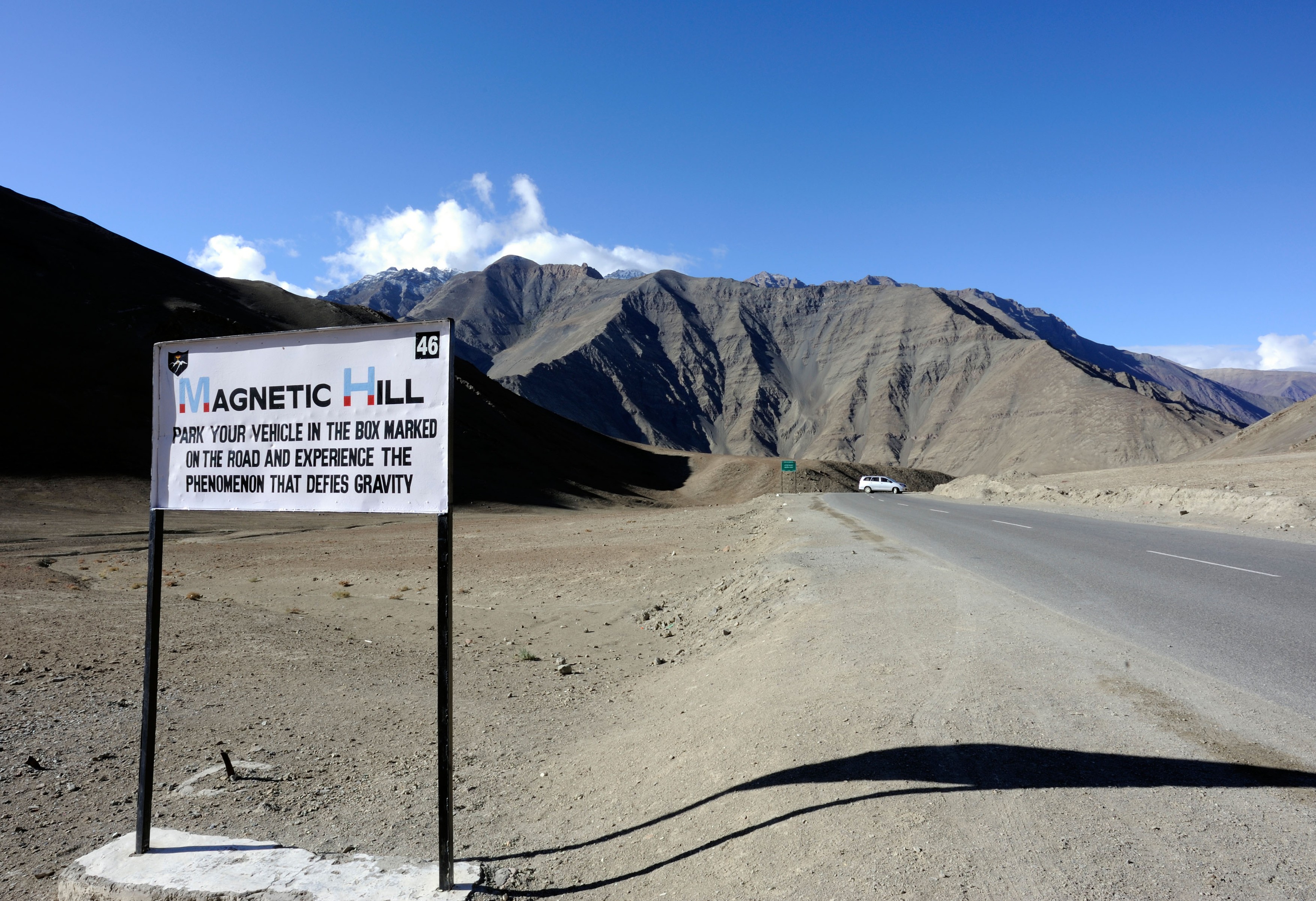 Sign for Magnetic Hill on the road from Leh to Kargil that claims to defy gravity. Near Nimu, Ladakh, Republic of India.