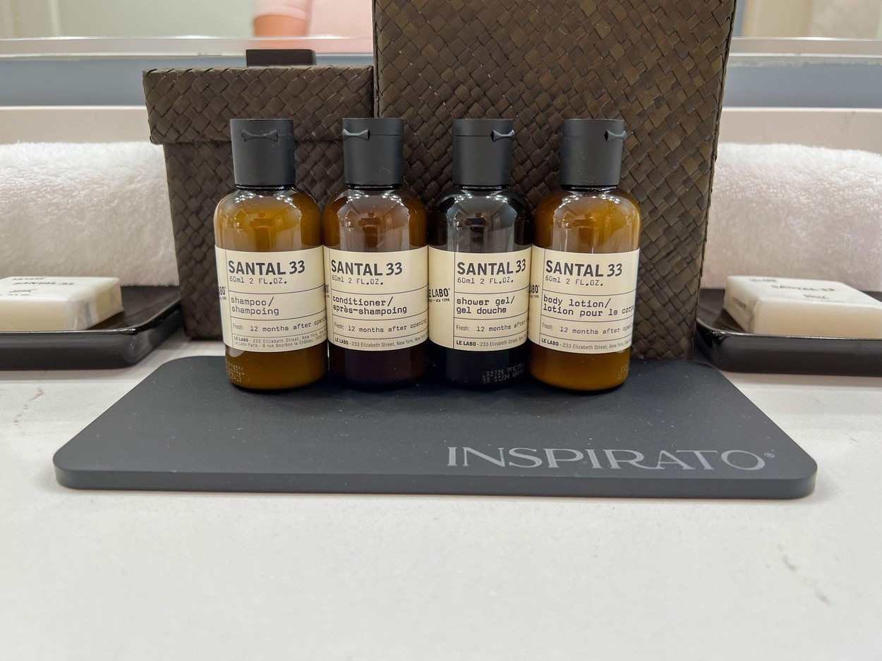 Watercolor, FL USA - July 24, 2022: A display of Santal 33 hand soap, body lotion, towels and shower accessories in a vacation home bathroom in Waterc