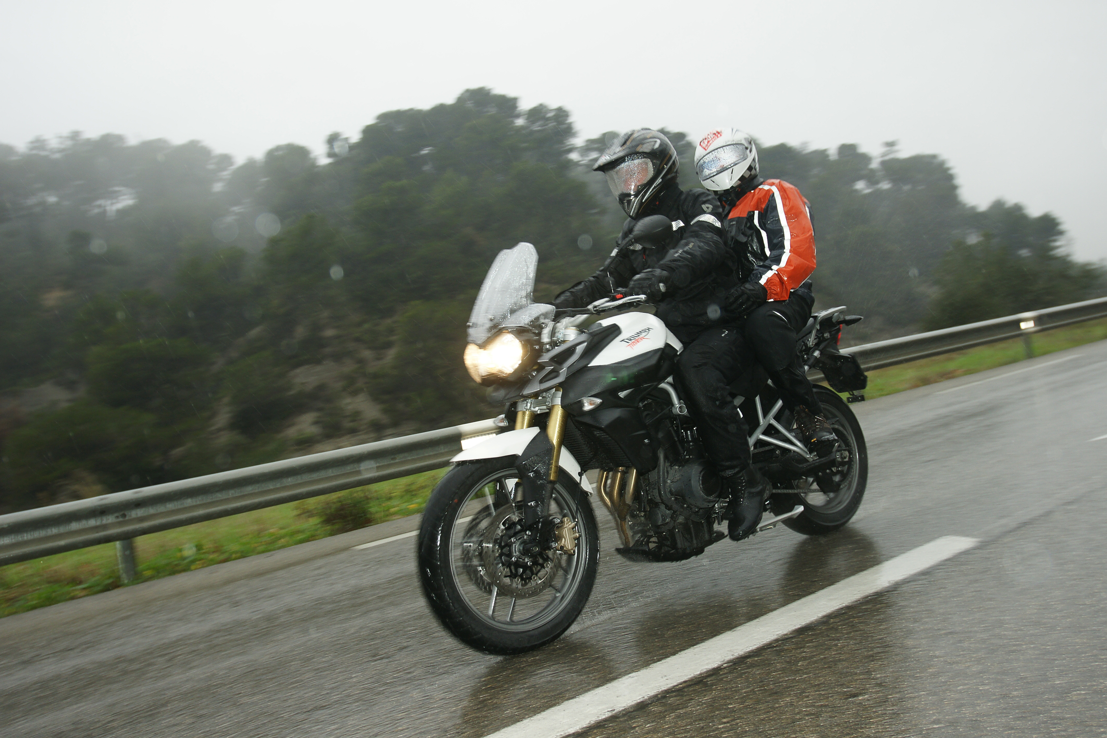Driving,A,Motorbike,In,Rainy,Weather,With,A,Passenger,Around