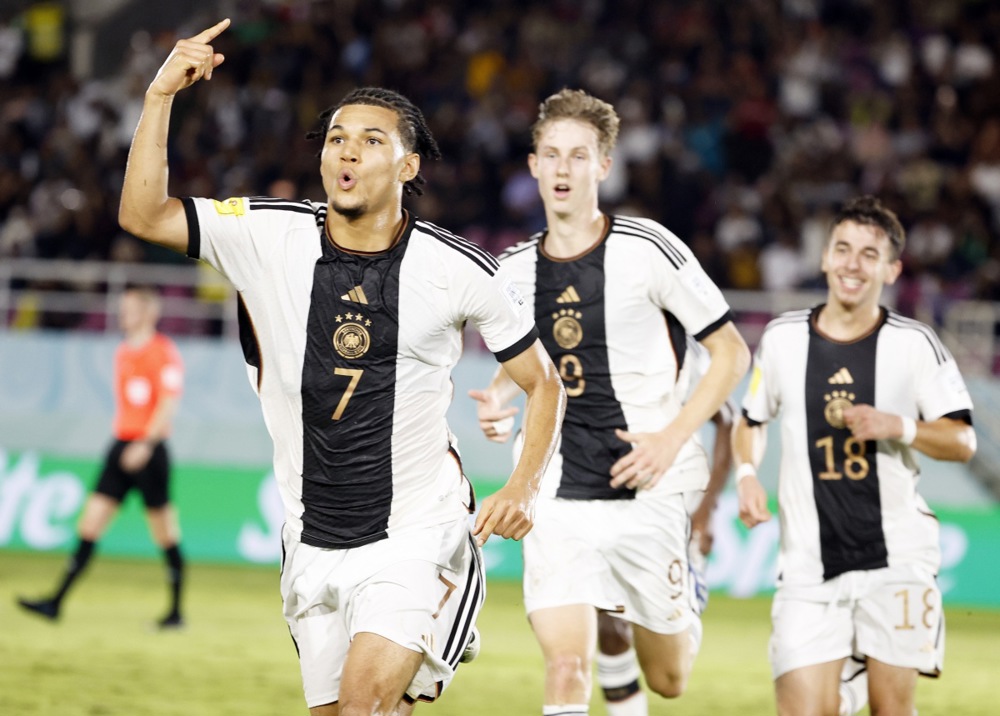 epa11007173 Paris Brunner (L) of Germany celebrates scoring the opening goal during the FIFA U-17 World Cup final match between Germany and France in Surakarta, Indonesia, 02 December 2023.  EPA-EFE/MAST IRHAM