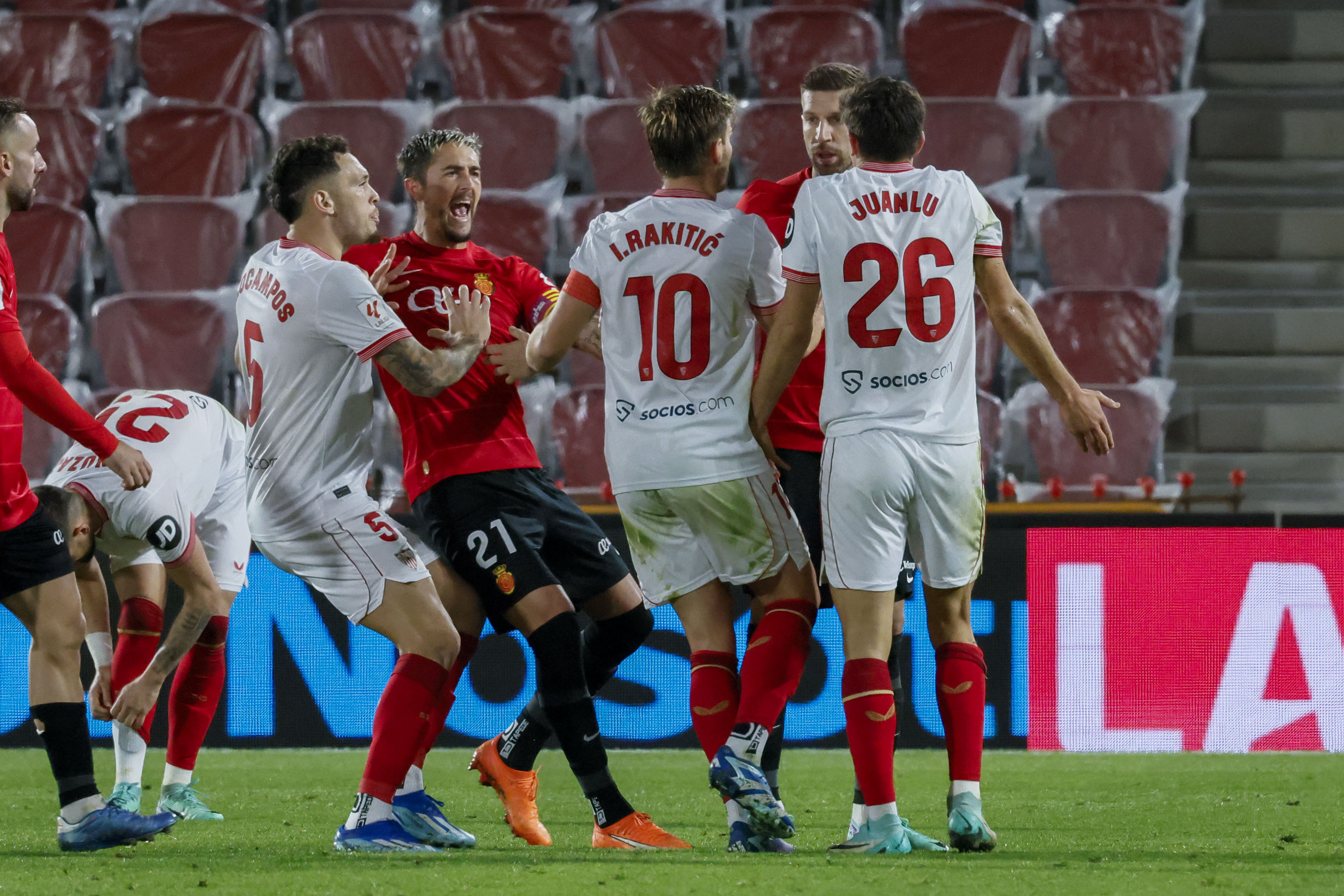 epa11020342 Mallorca and Sevilla players scuffle during the Spanish LaLiga soccer match between RCD Mallorca and Sevilla FC at Son Moix stadium in Palma de Mallorca, Balearic Islands, Spain, 09 December 2023.  EPA-EFE/CATI CLADERA