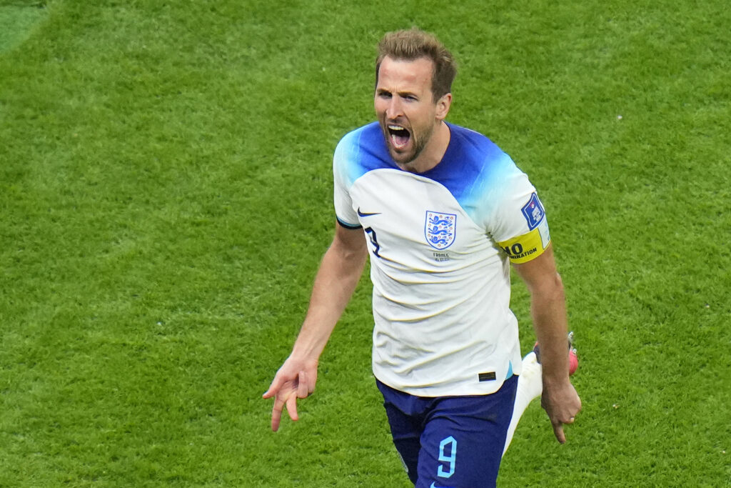 England's Harry Kane celebrates after scoring his side's opening goal during the World Cup quarterfinal soccer match between England and France, at the Al Bayt Stadium in Al Khor, Qatar, Saturday, Dec. 10, 2022. (AP Photo/Hassan Ammar)