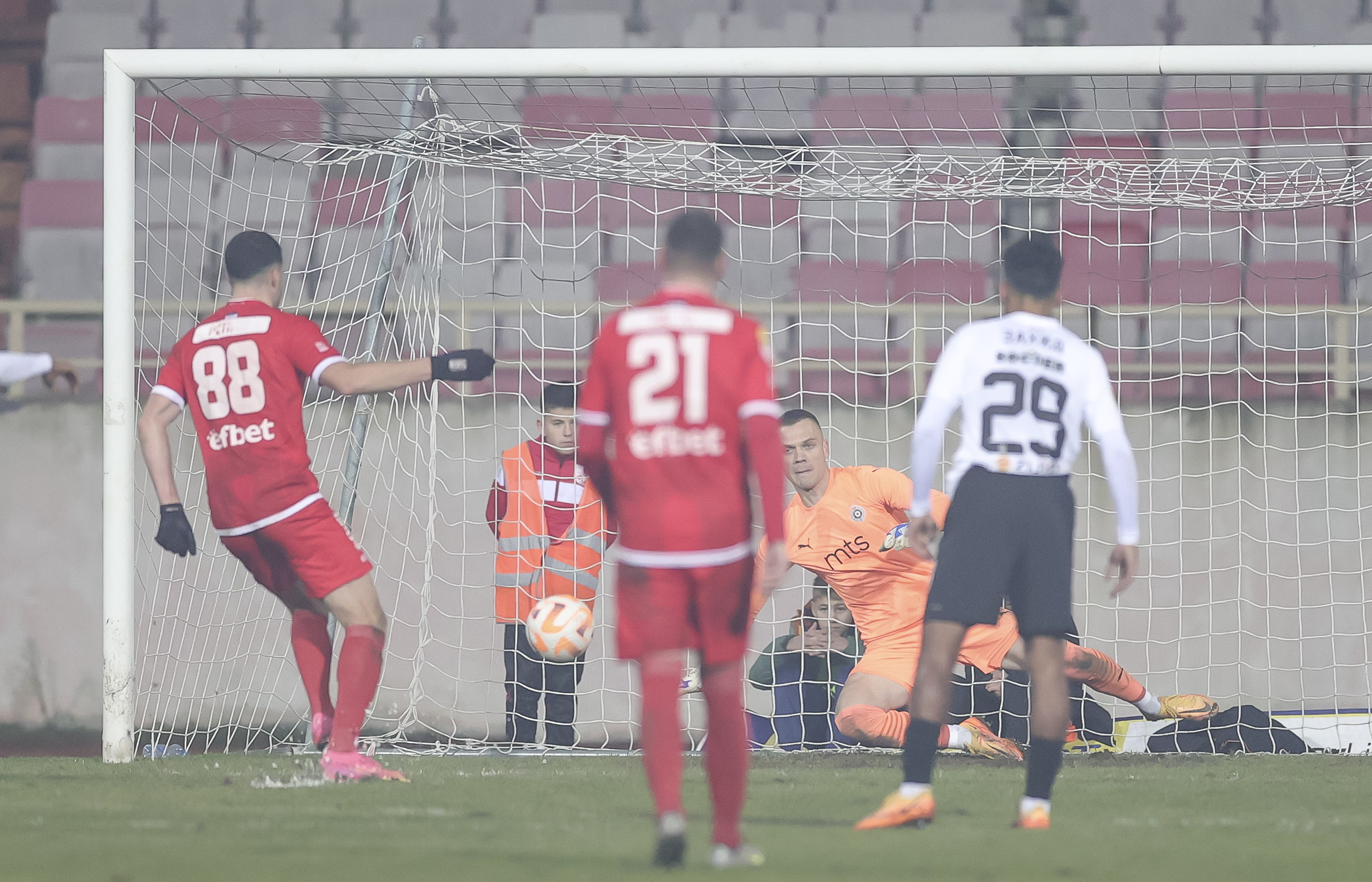 Sava Petrov (L) scores the goal near goalkeeper Aleksandar Jovanovic during the Mozzart Super Liga Season 2023/2024 match between Radnicki Nis and Partizan at stadium Cair on December 11, 2023 in Nis, Serbia. (Photo by Srdjan Stevanovic/Starsport.rs ©)