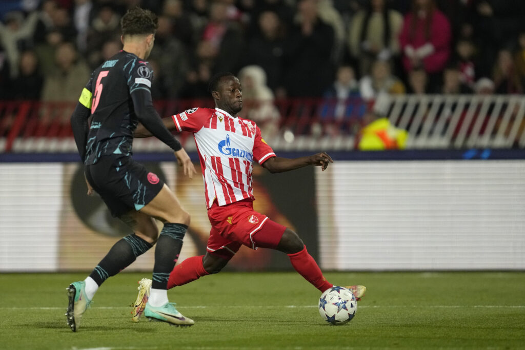 Manchester City's John Stones and Red Star's Osman Bukari in action during the Group G Champions League soccer match between Red Star and Manchester City, at the Rajko Mitic Stadium in Belgrade, Serbia, Wednesday, Dec. 13, 2023. (AP Photo/Darko Vojinovic)